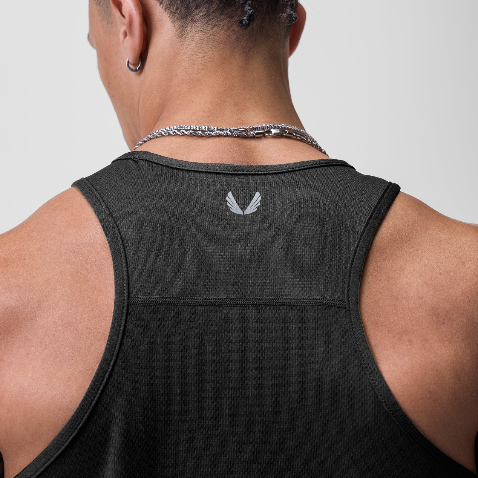 AeroSilver Training Singlet in black, worn by model showing back view with logo detail