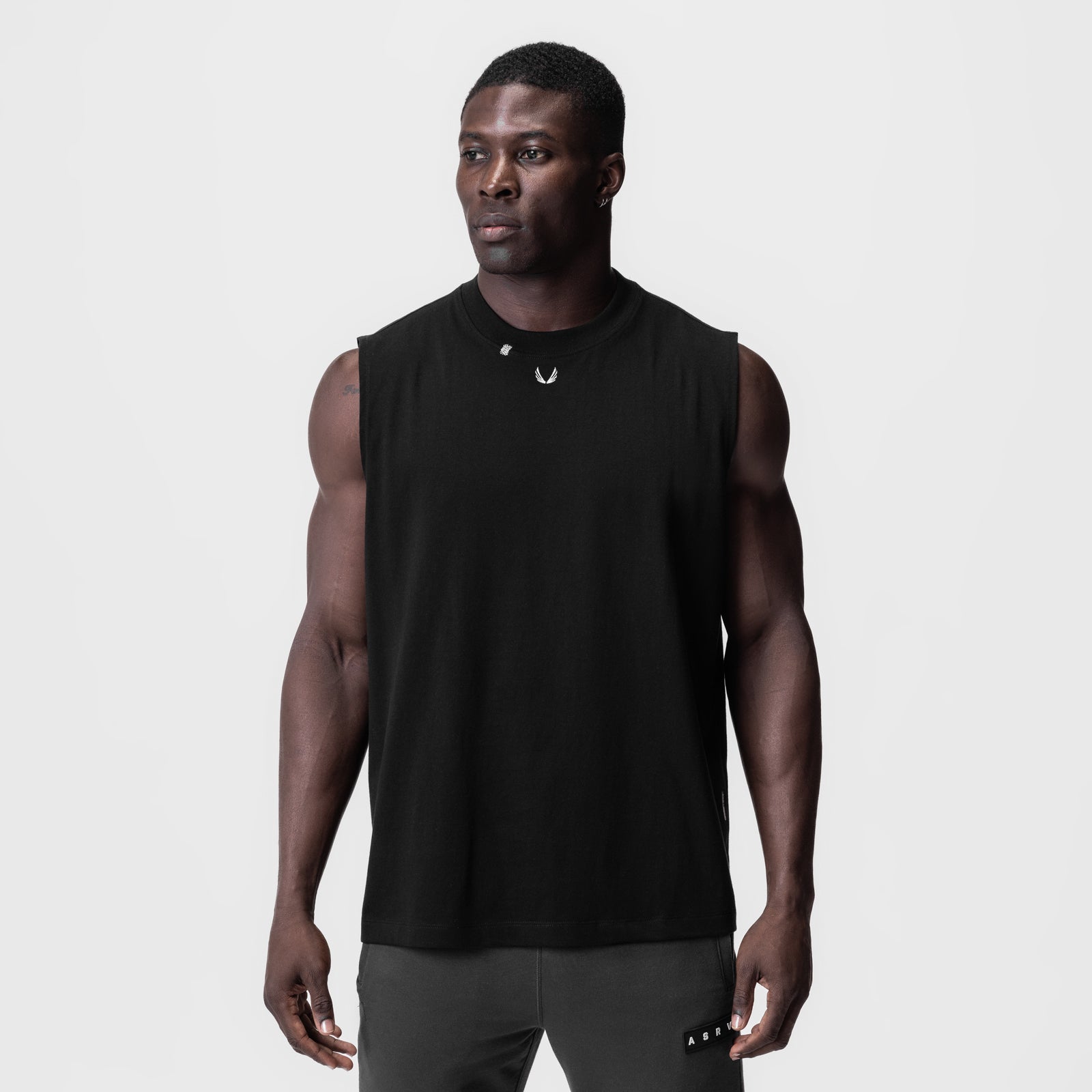 Black Tech Essential Relaxed Cutoff tank top on model, front view