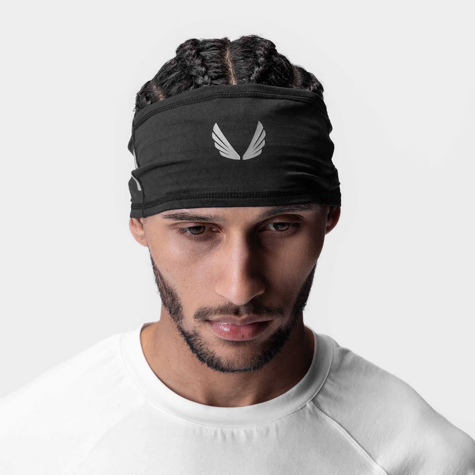 Black ASRV Outlast Phase Change Headband with reflective wings logo, worn on model