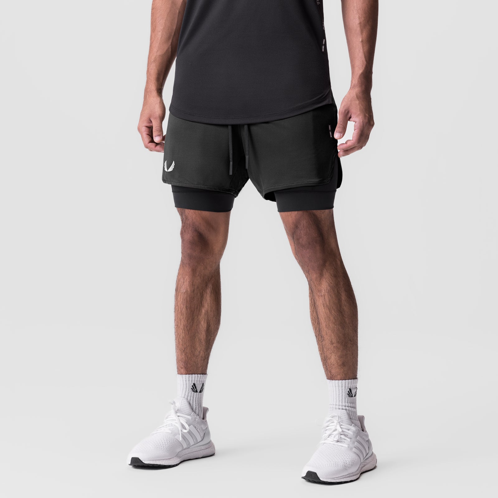 AeroSilver 5" Liner Short in black with white detailing, worn by model with white sneakers, front view
