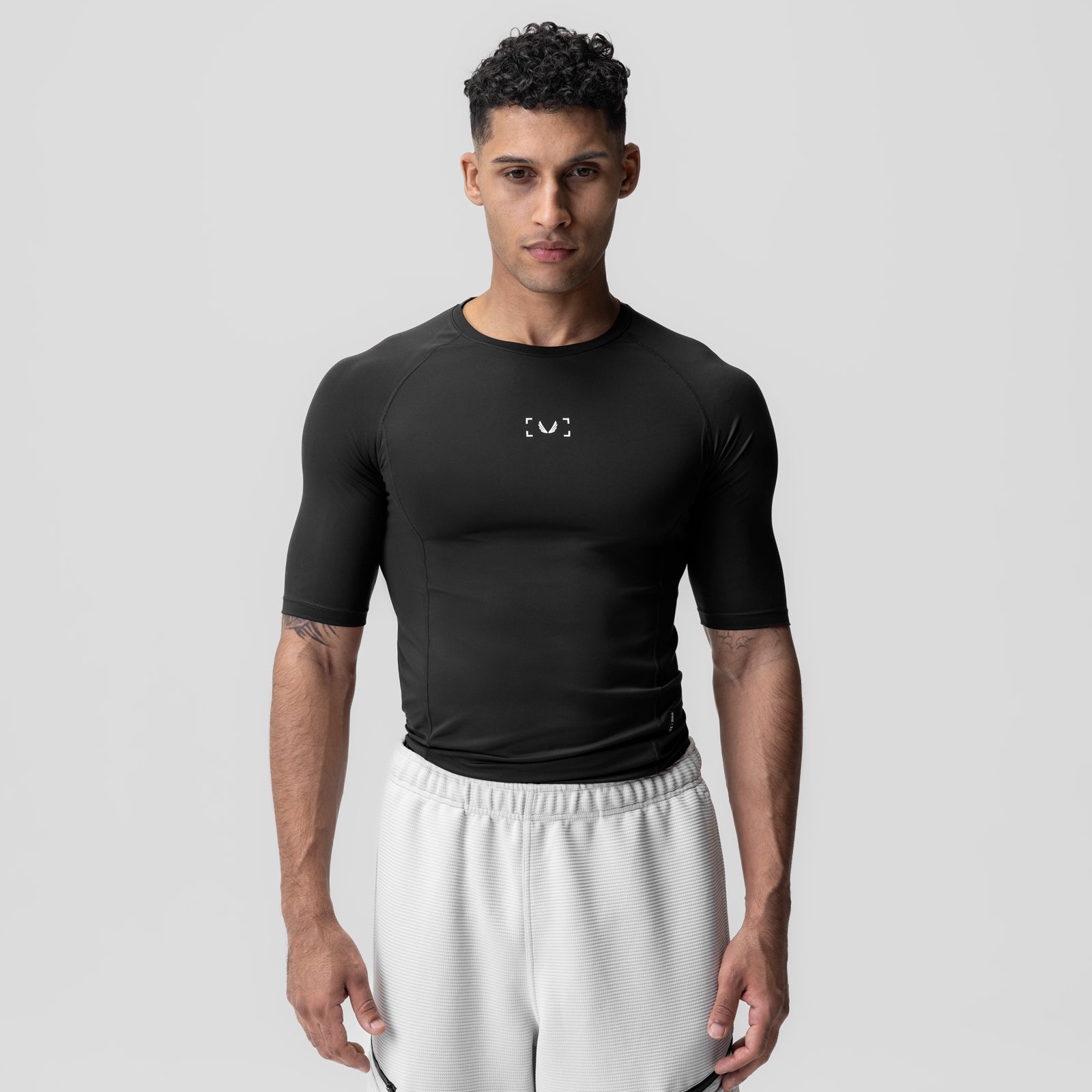 WarpFlexx-Lite® Half-Sleeve Baselayer in black, worn by model with white pants