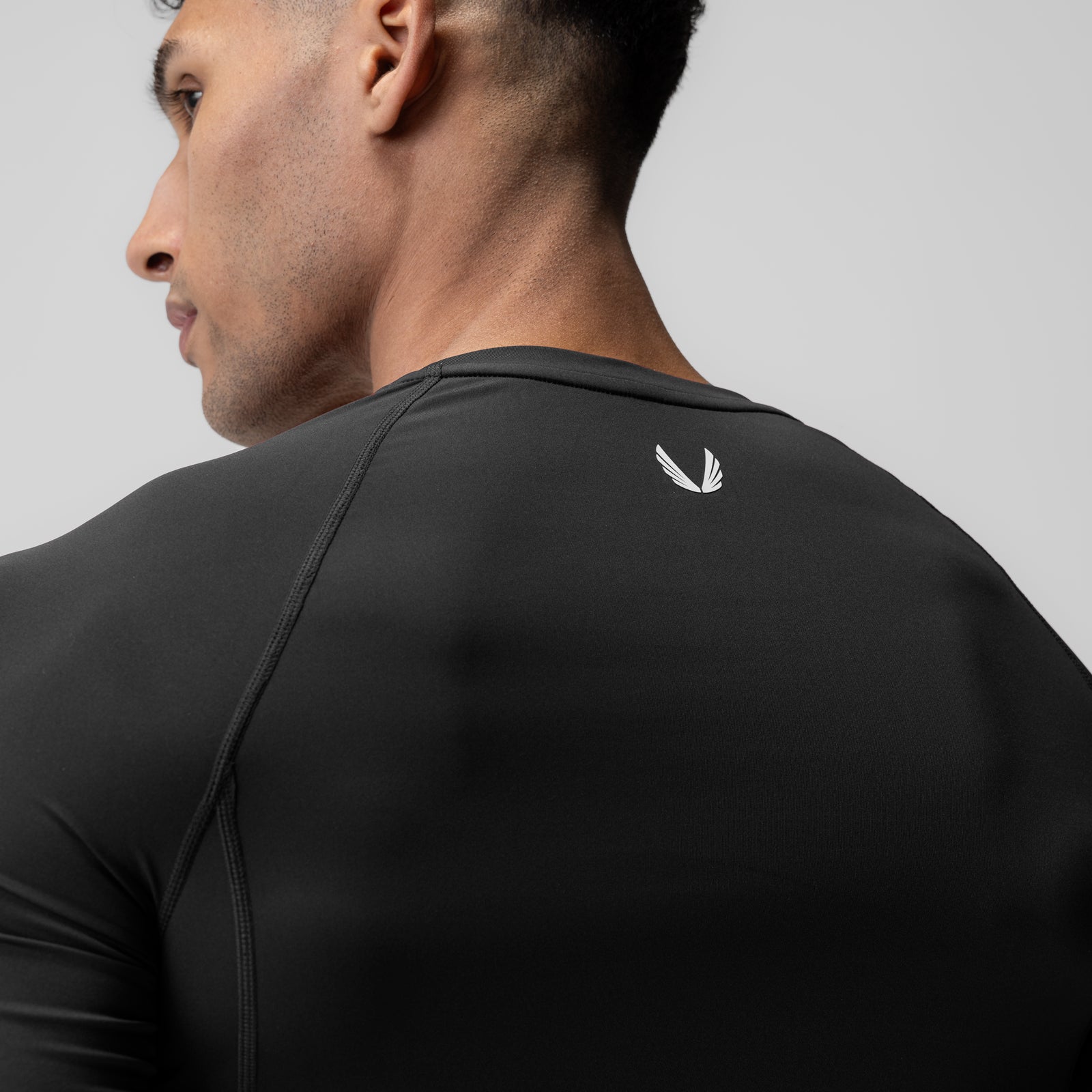 WarpFlexx-Lite® Half-Sleeve Baselayer in black, worn by model in profile view