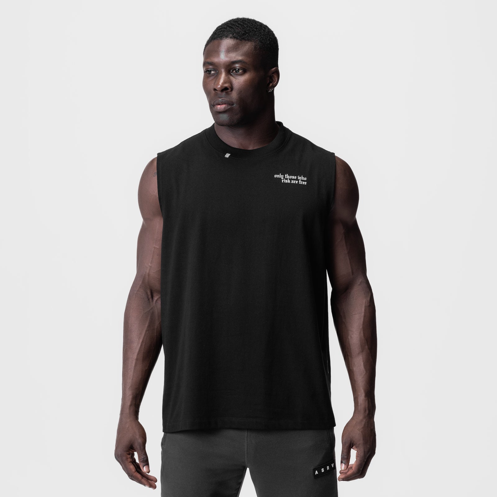 Black Tech Essential Relaxed Cutoff sleeveless tank worn by male model, front view