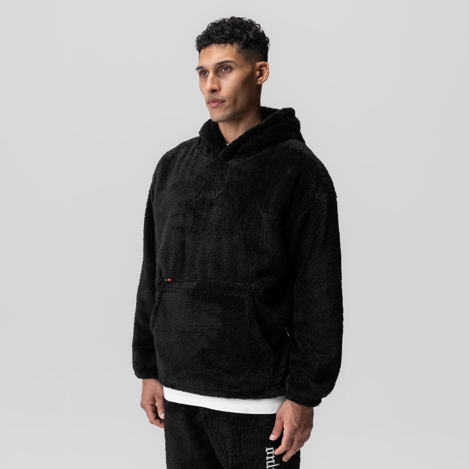 Black Sherpa Recovery Hoodie worn by model, three-quarter view