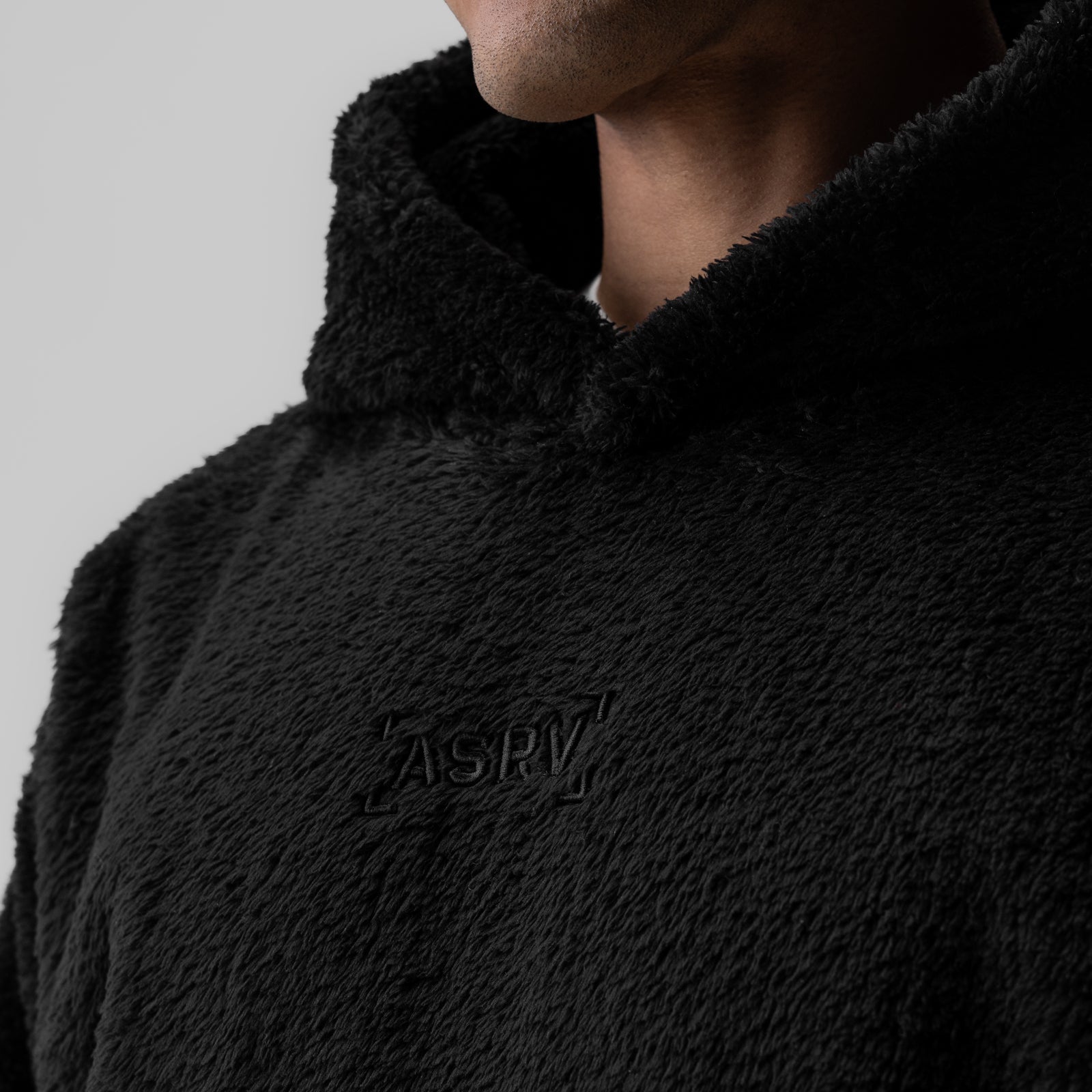 Black Sherpa Recovery Hoodie worn by model, chest detail showing ASRV logo