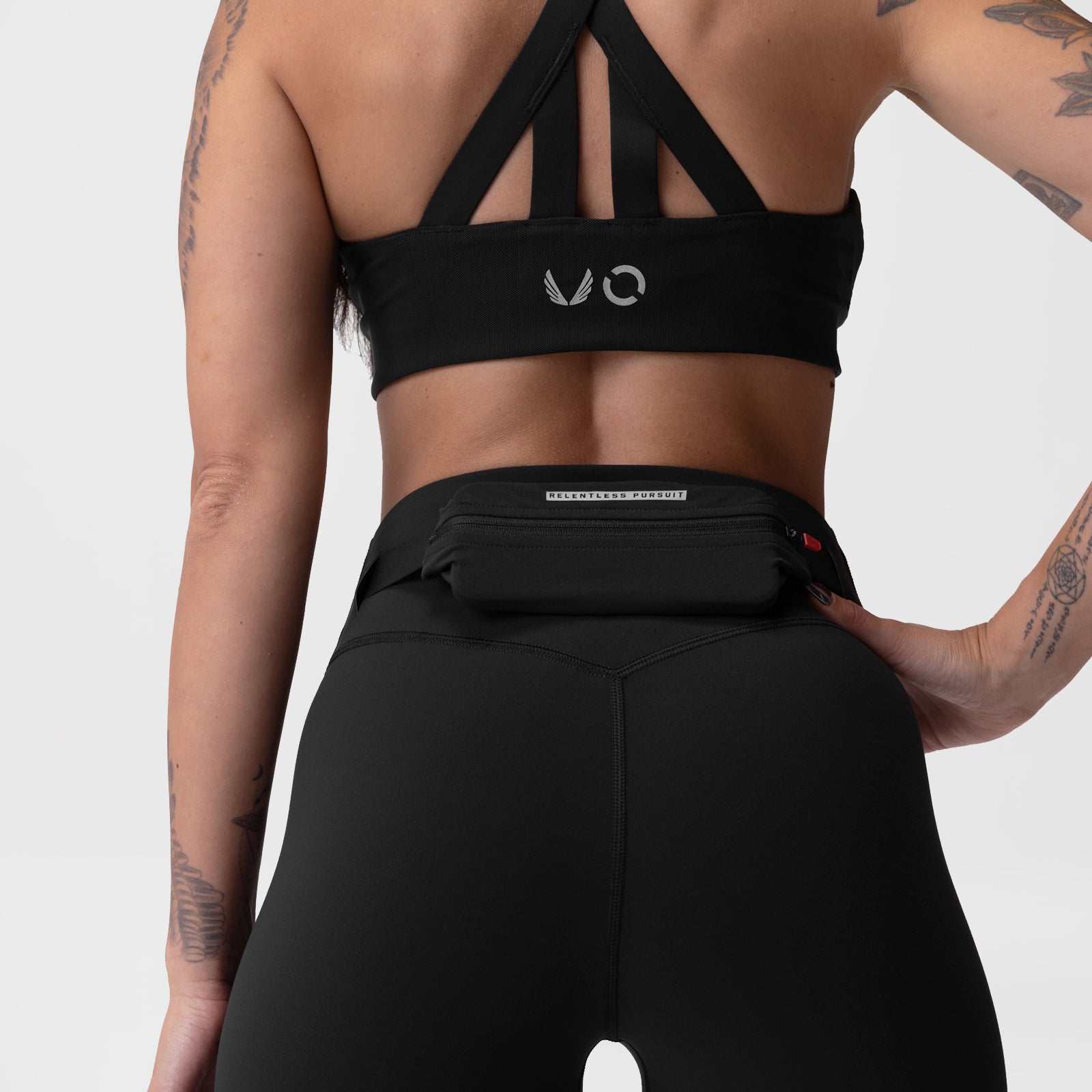 Black 3-in-1 legging with built-in shorts worn by model, back view