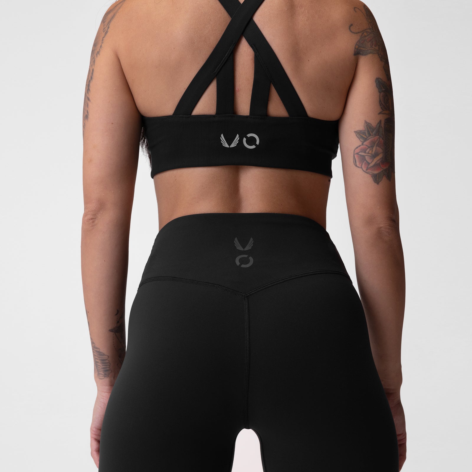 Black Lycra 3-in-1 legging worn by model, back view showing cross-strap sports bra