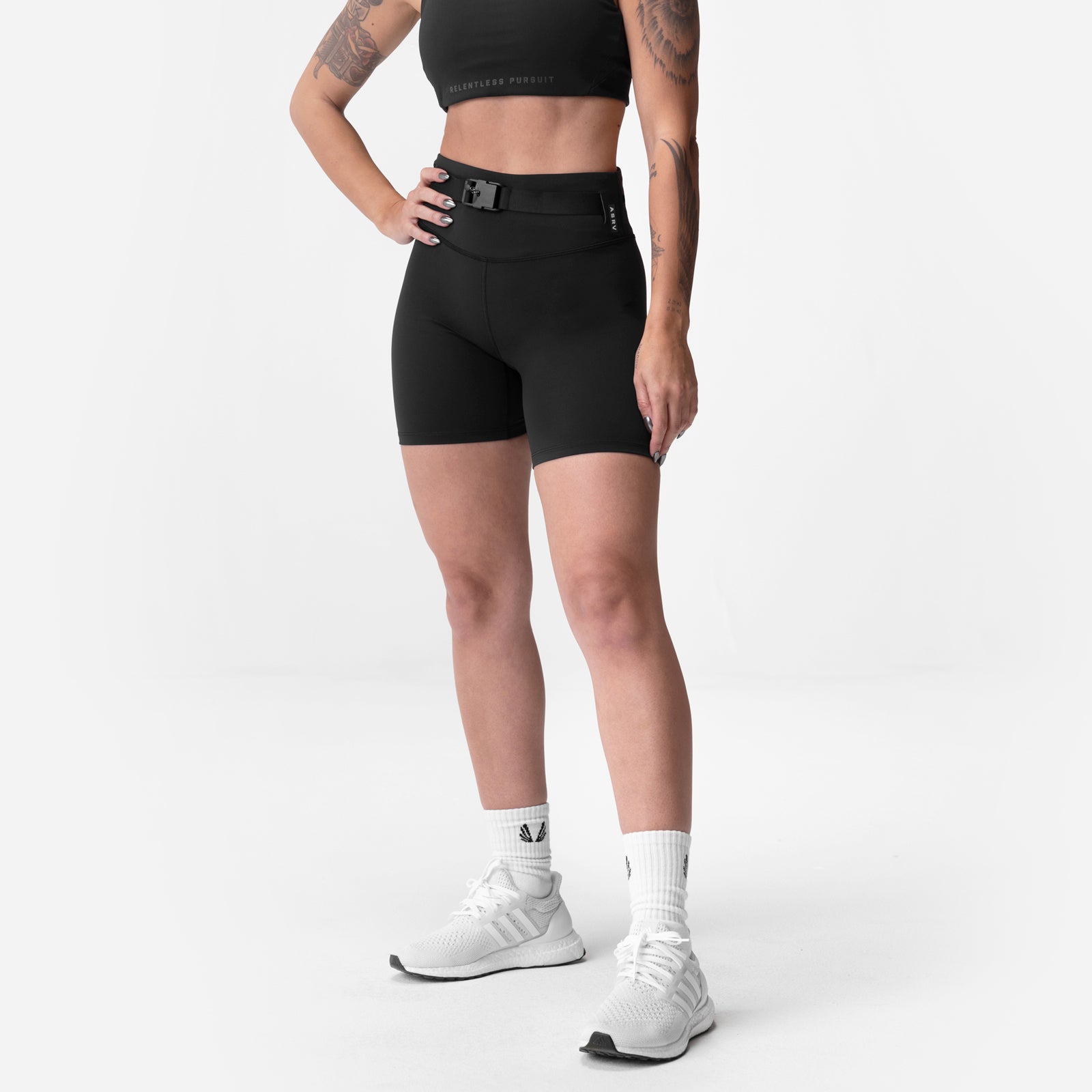Black ASRV Lycra® 3-in-1 biker shorts with belt, worn by model standing sideways