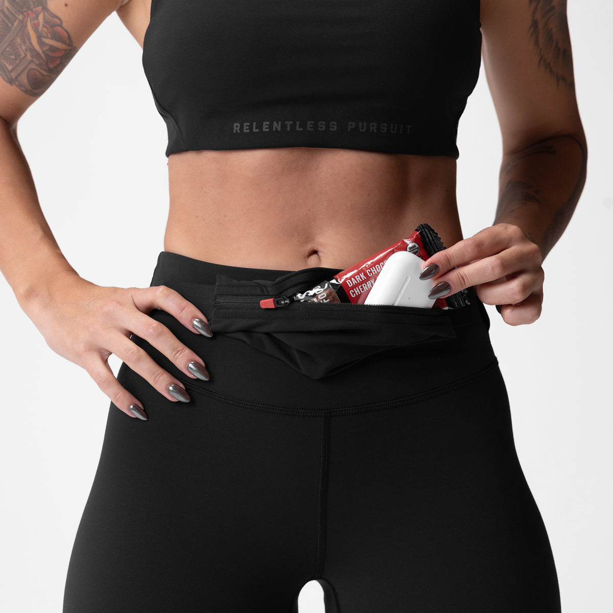 Black Lycra 3-in-1 legging worn by model, demonstrating waistband pocket detail