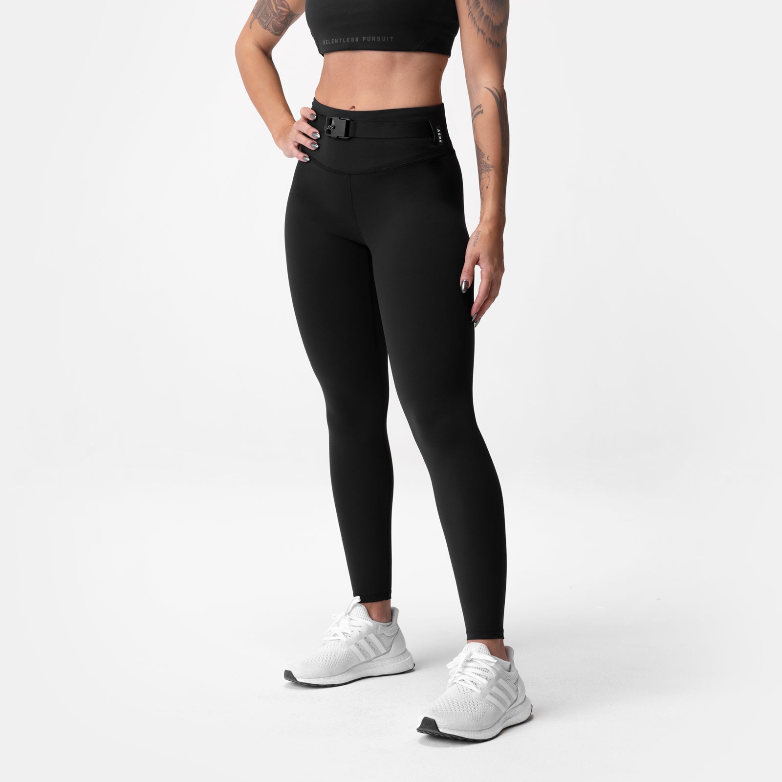 Black Lycra 3-in-1 legging worn by model, front view with white sneakers