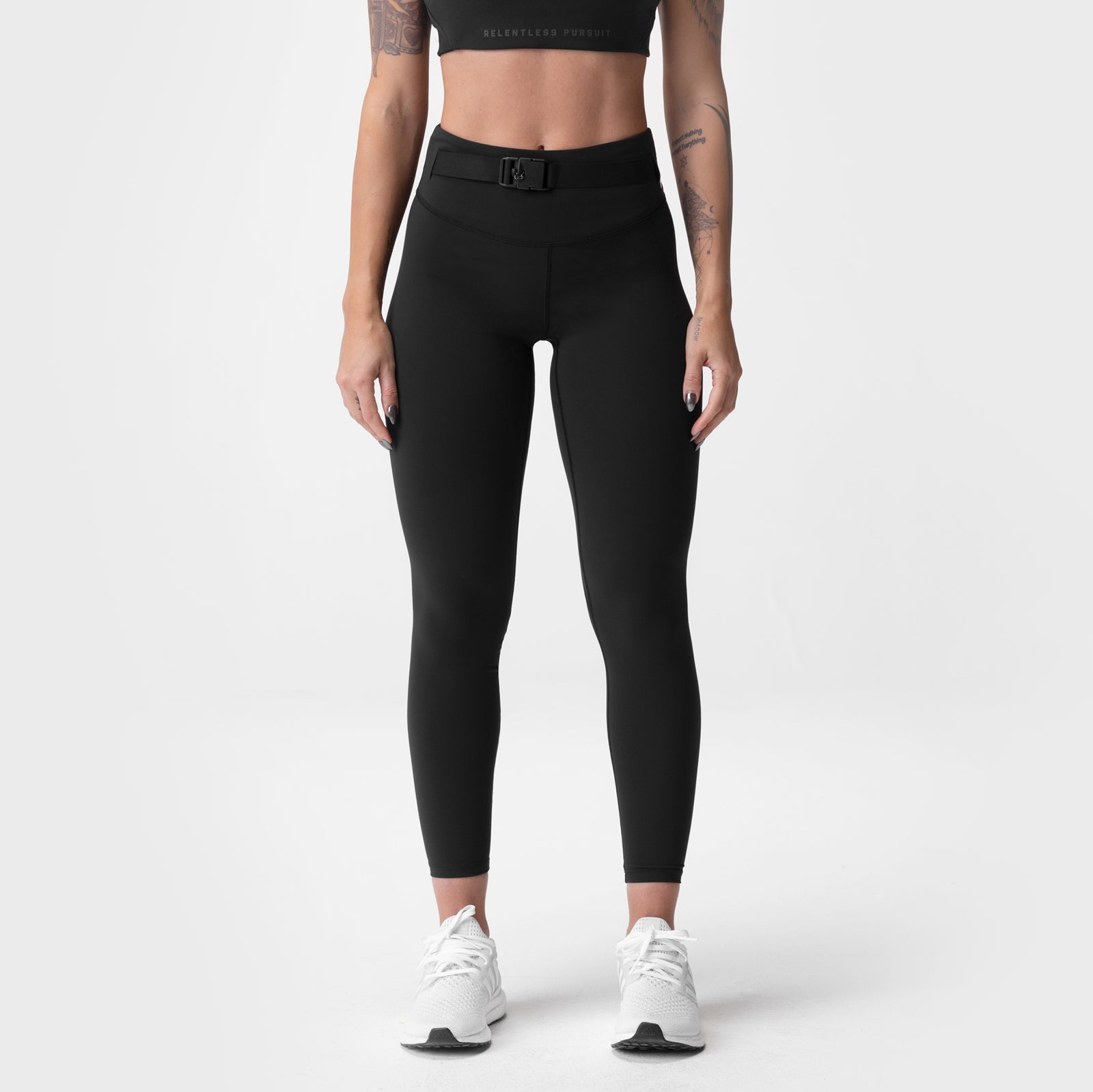 ASRV x Equinox Lycra® 3-In-1 Legging in black, worn by model with white sneakers