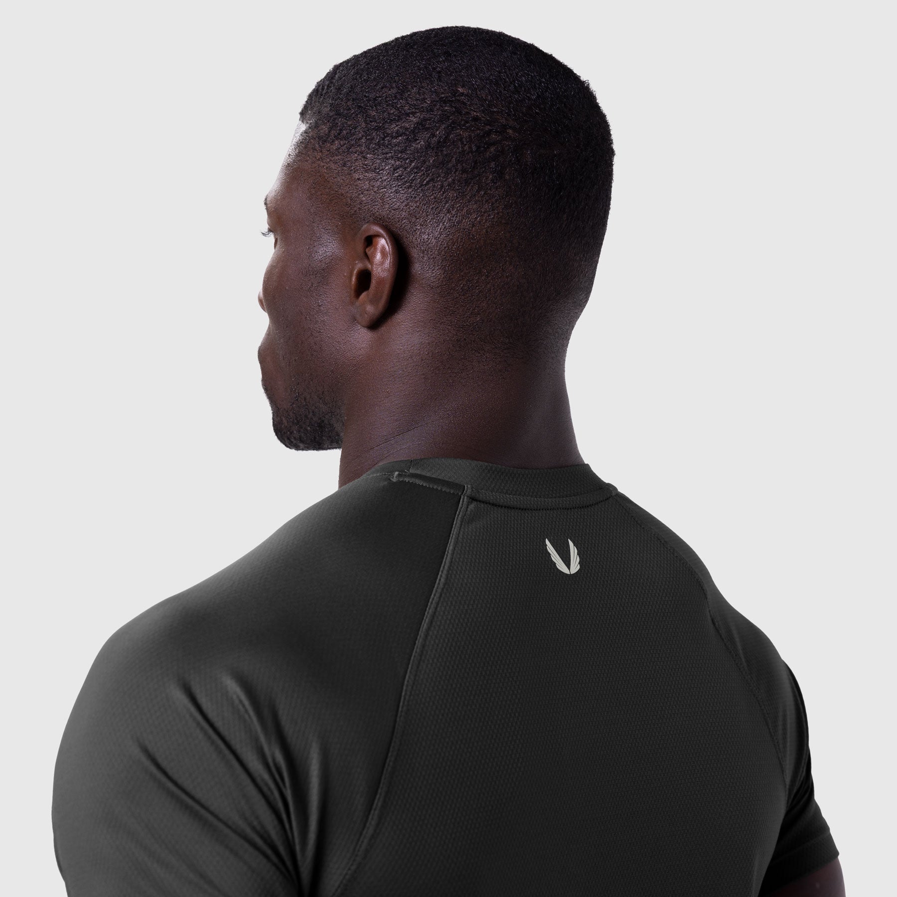AeroSilver Established Tee in black worn by model, back view