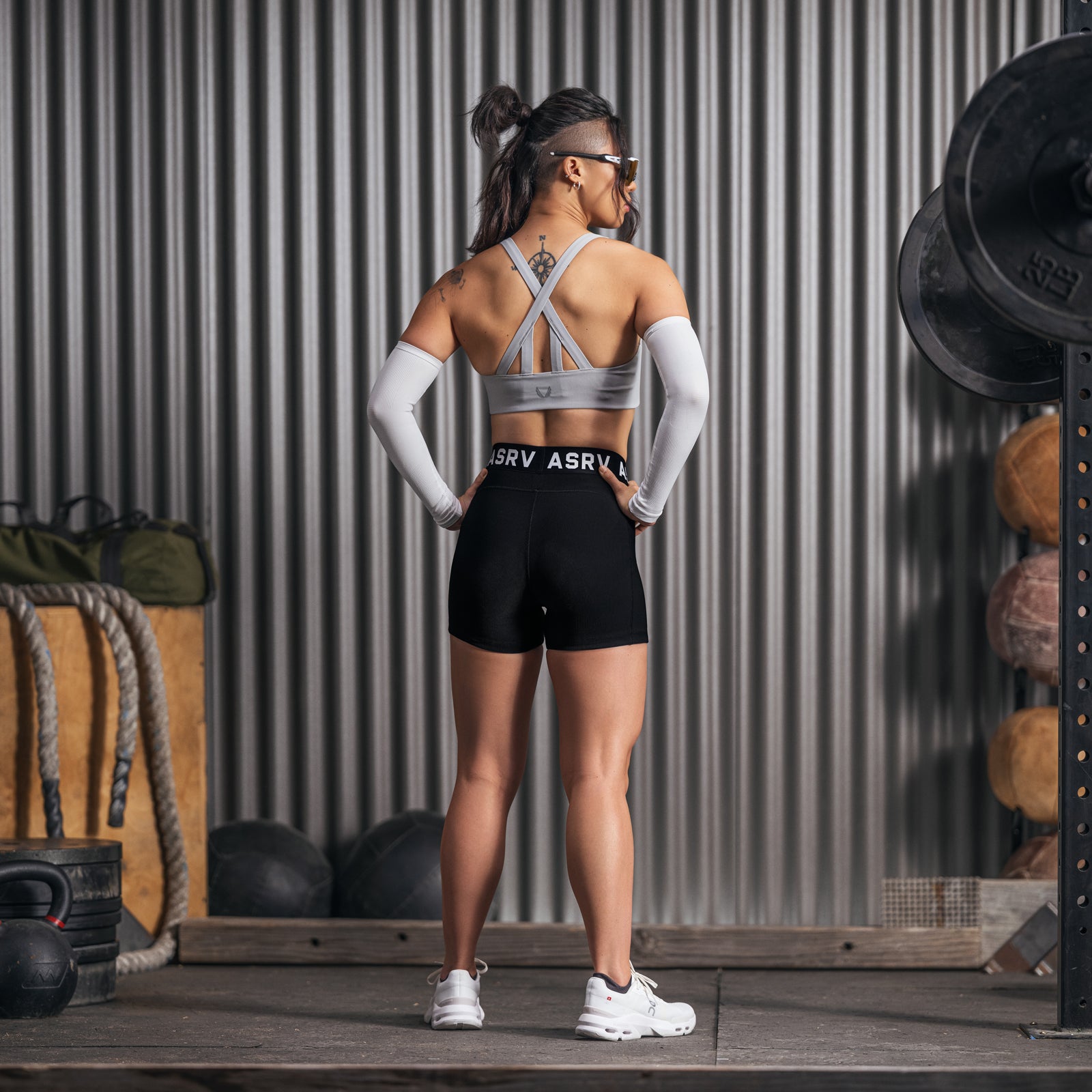 W027 Lycra Ribbed Short in black, worn with sports bra, back view