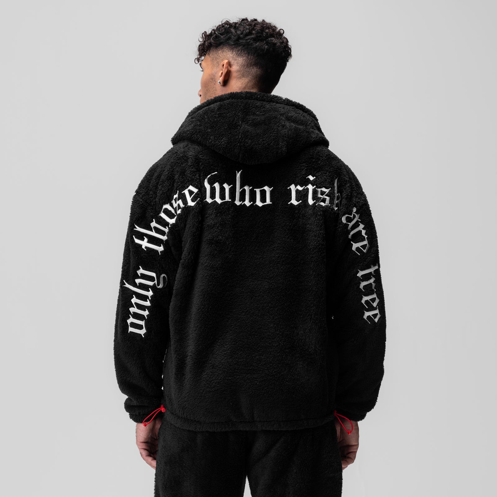 Black Sherpa Recovery Hoodie worn by model, back view showing white text design