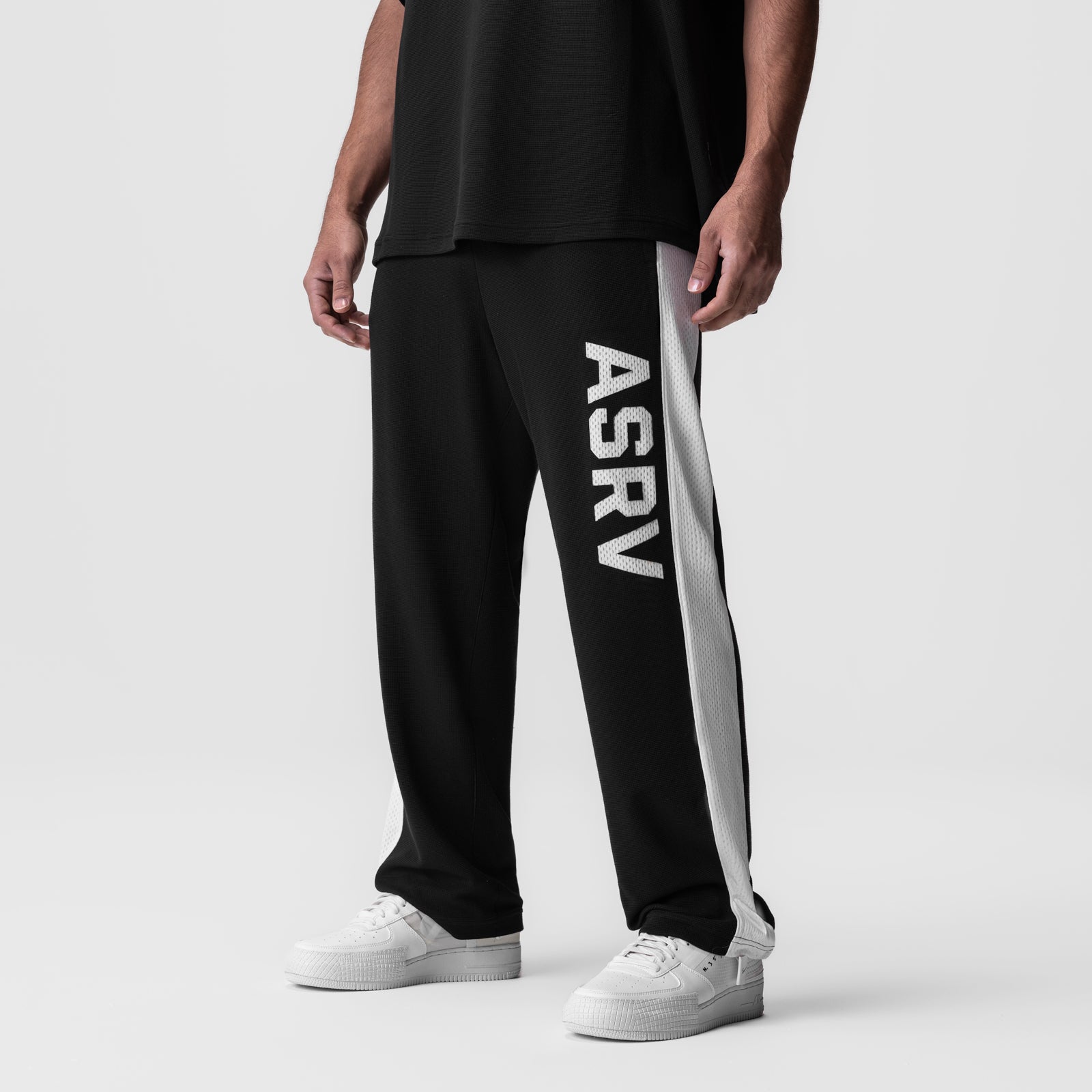 Waffle Knit Relaxed Sweatpant in black with white side stripe, modeled on figure
