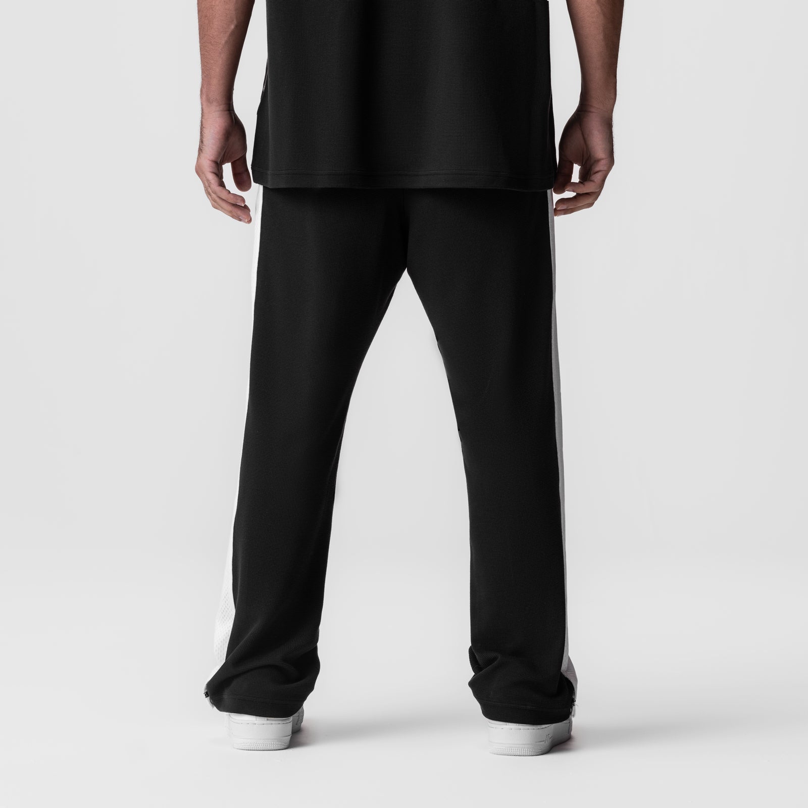Black and white waffle knit relaxed sweatpant worn by model, back view