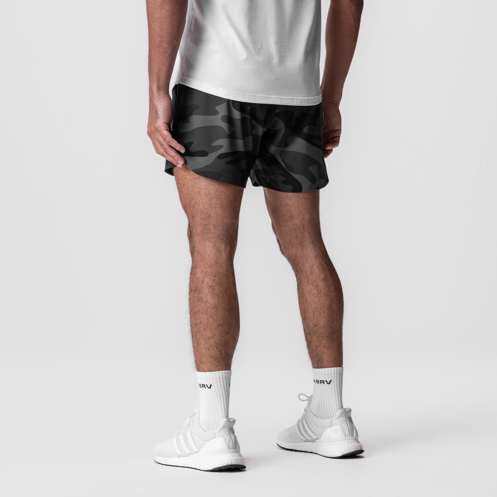 Tetra-Lite 5" Linerless Short in black camo, worn with white socks and sneakers, back view