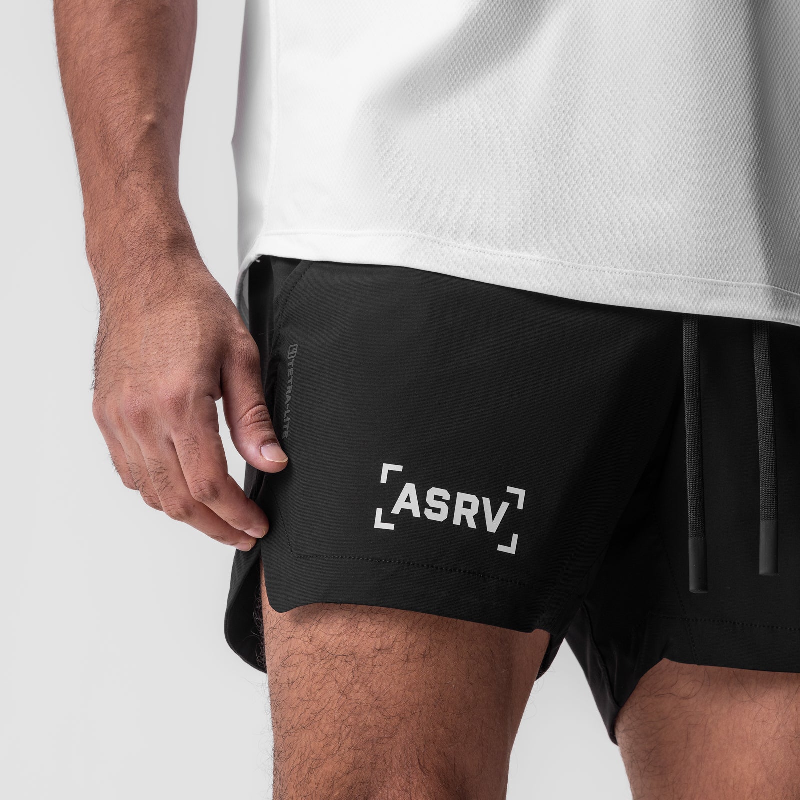 Tetra-Lite 5" Linerless Short in black with white bracket logo, worn by model, side view