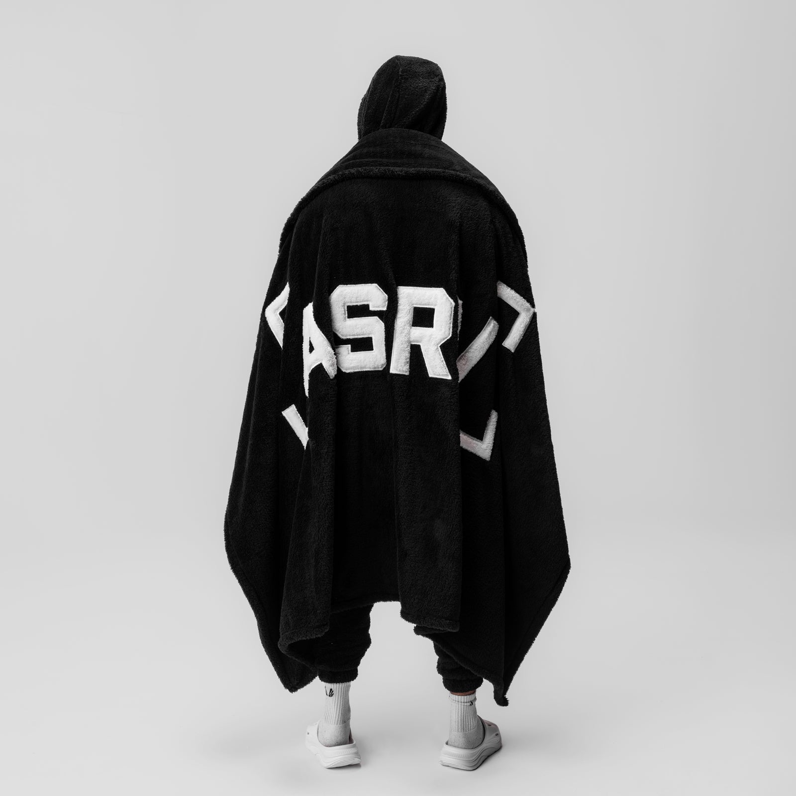 Black Sherpa Recovery Blanket with white ASRV logo, worn by model from behind