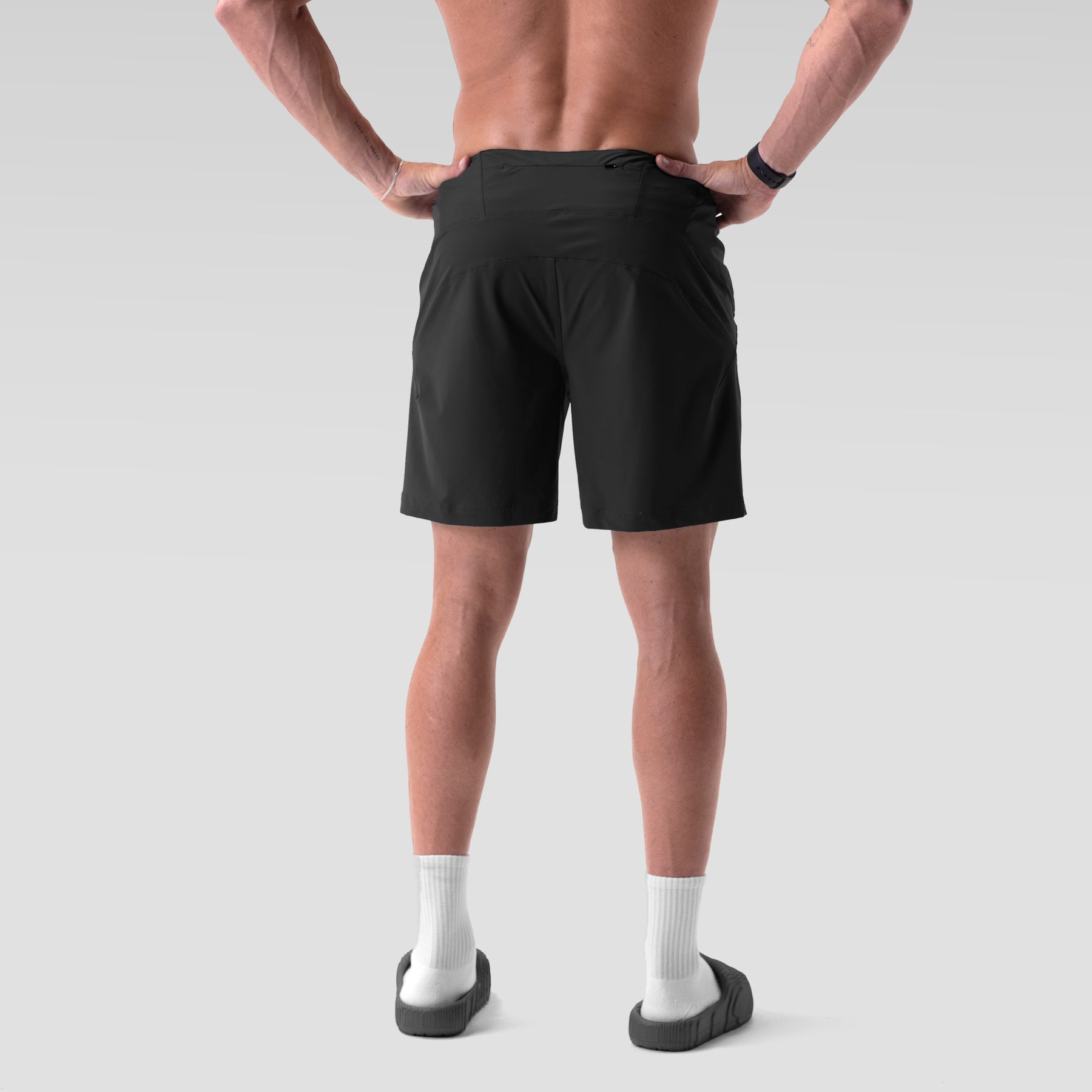 Black Revolutional® Board Short worn by model, back view