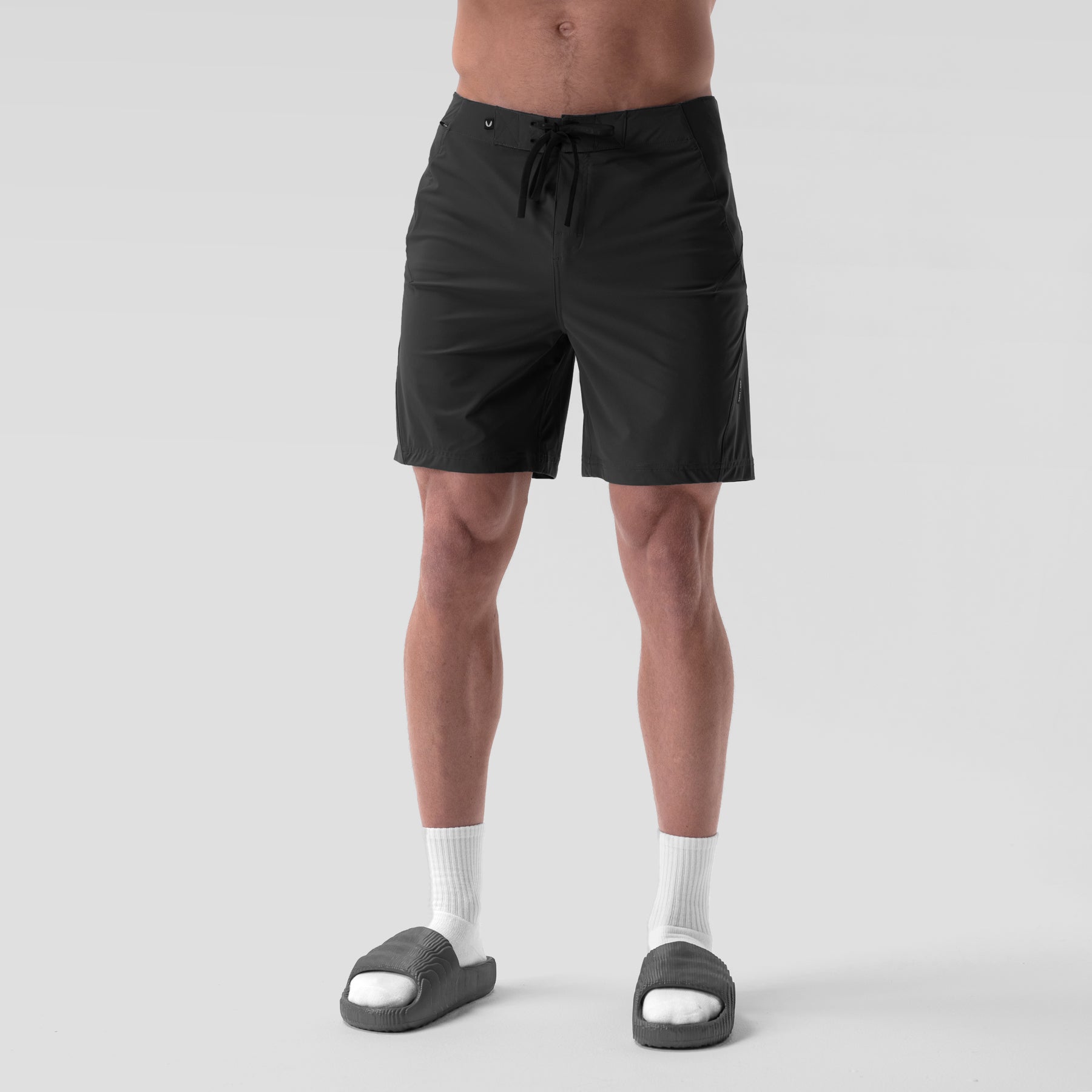 Revolutional® Board Short in black worn by model, front view