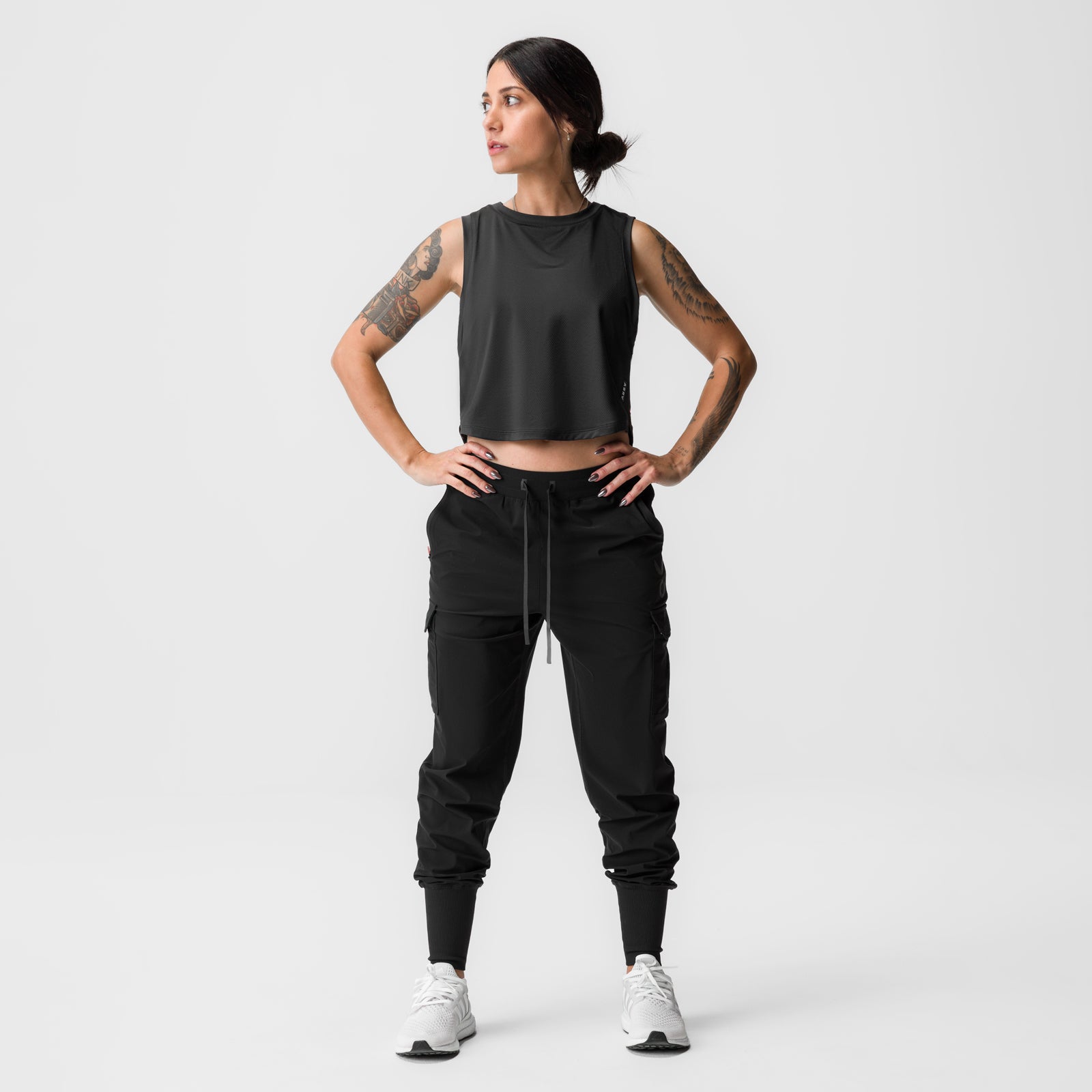 Black cropped training tank on model, front pose with hands on hips