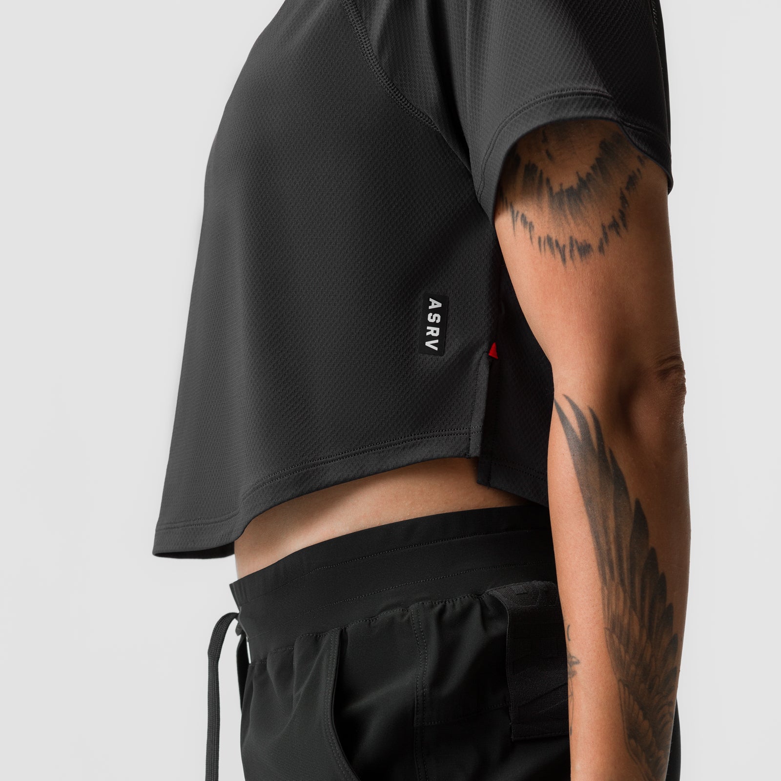 Black AeroSilver cropped training tee worn by model, side view