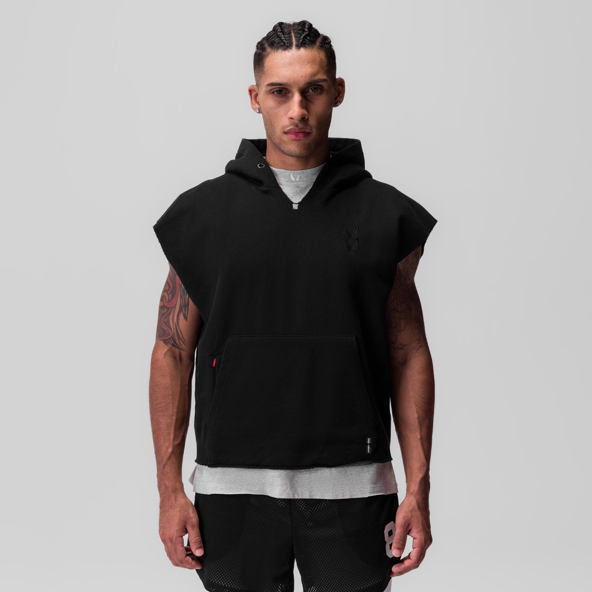 Tech Essential Raw Hem Cutoff Hoodie in black, worn by model, front view