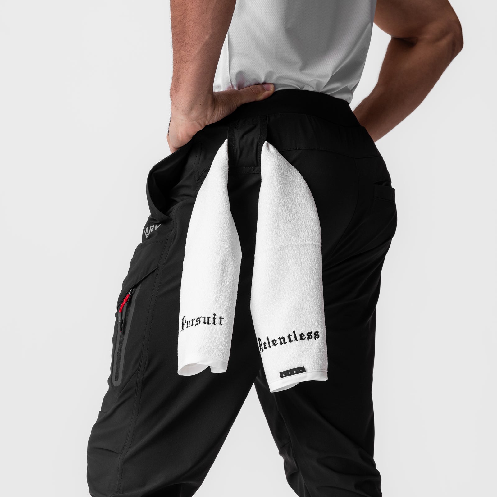 Black Tetra-Lite Tech High Rib Jogger worn by model holding white towel with 'Relentless' text
