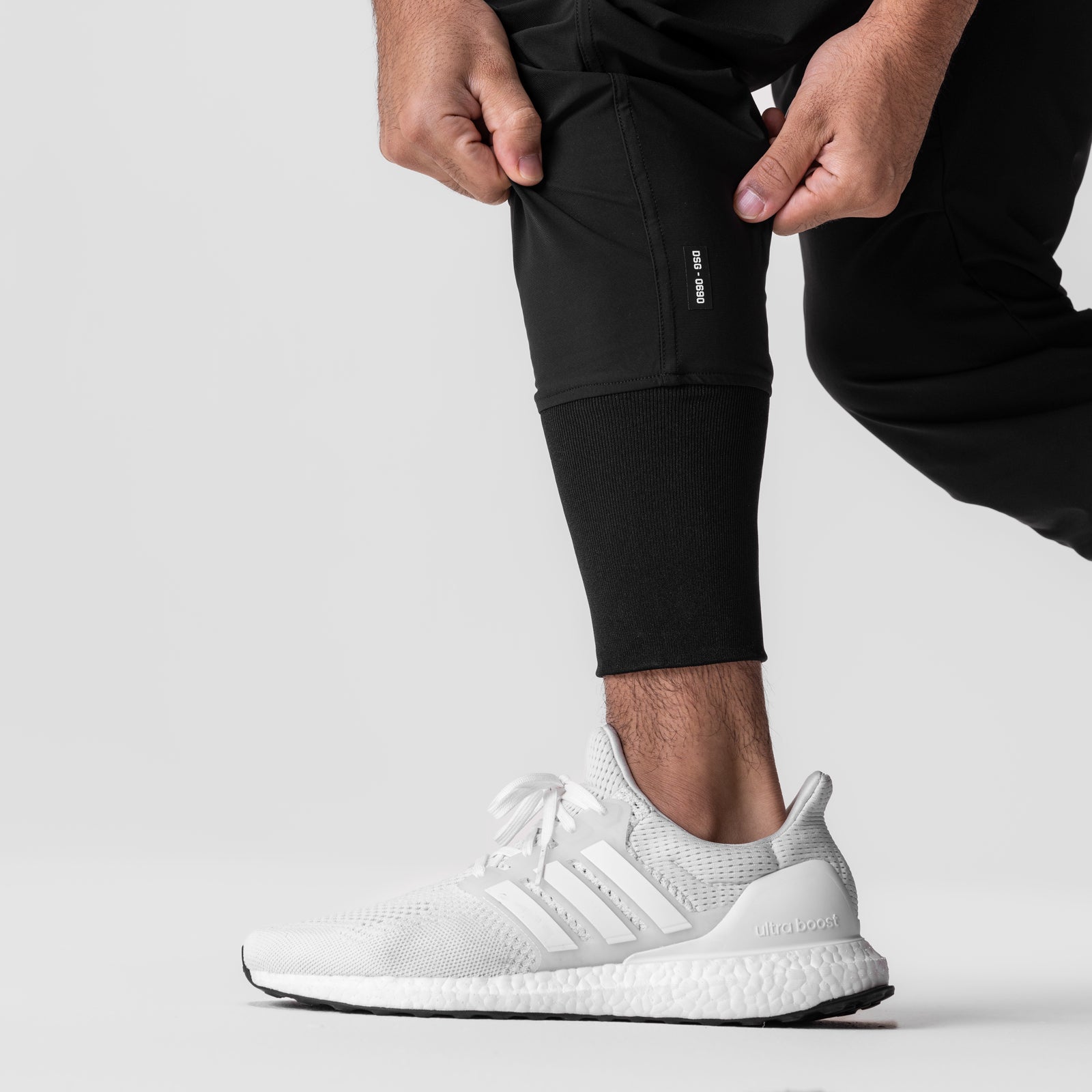 Black Tetra-Lite® Tech High Rib Jogger worn with white sneakers, cropped side view