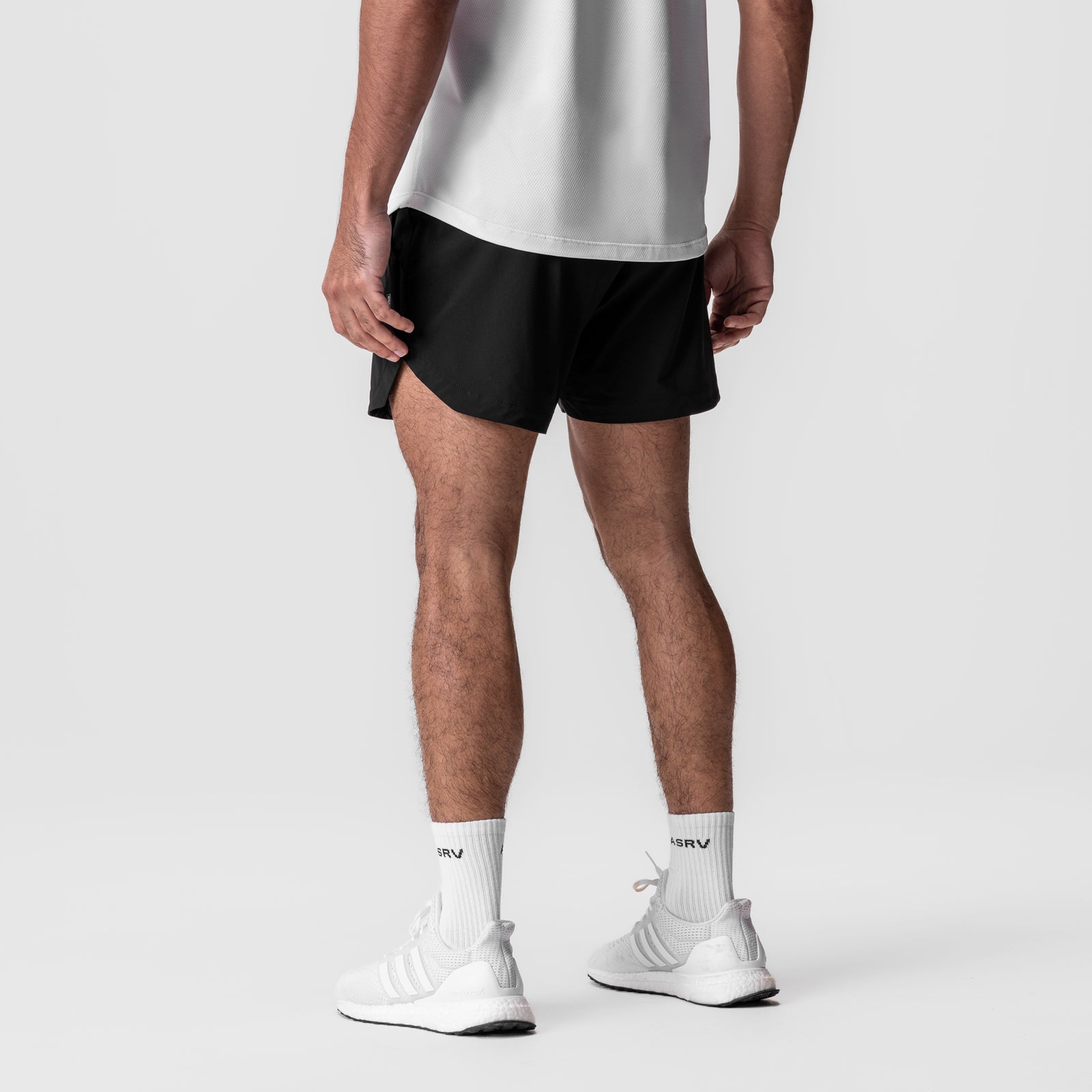 Tetra-Lite 5" Linerless Short in black, worn by model from waist down with white socks and sneakers