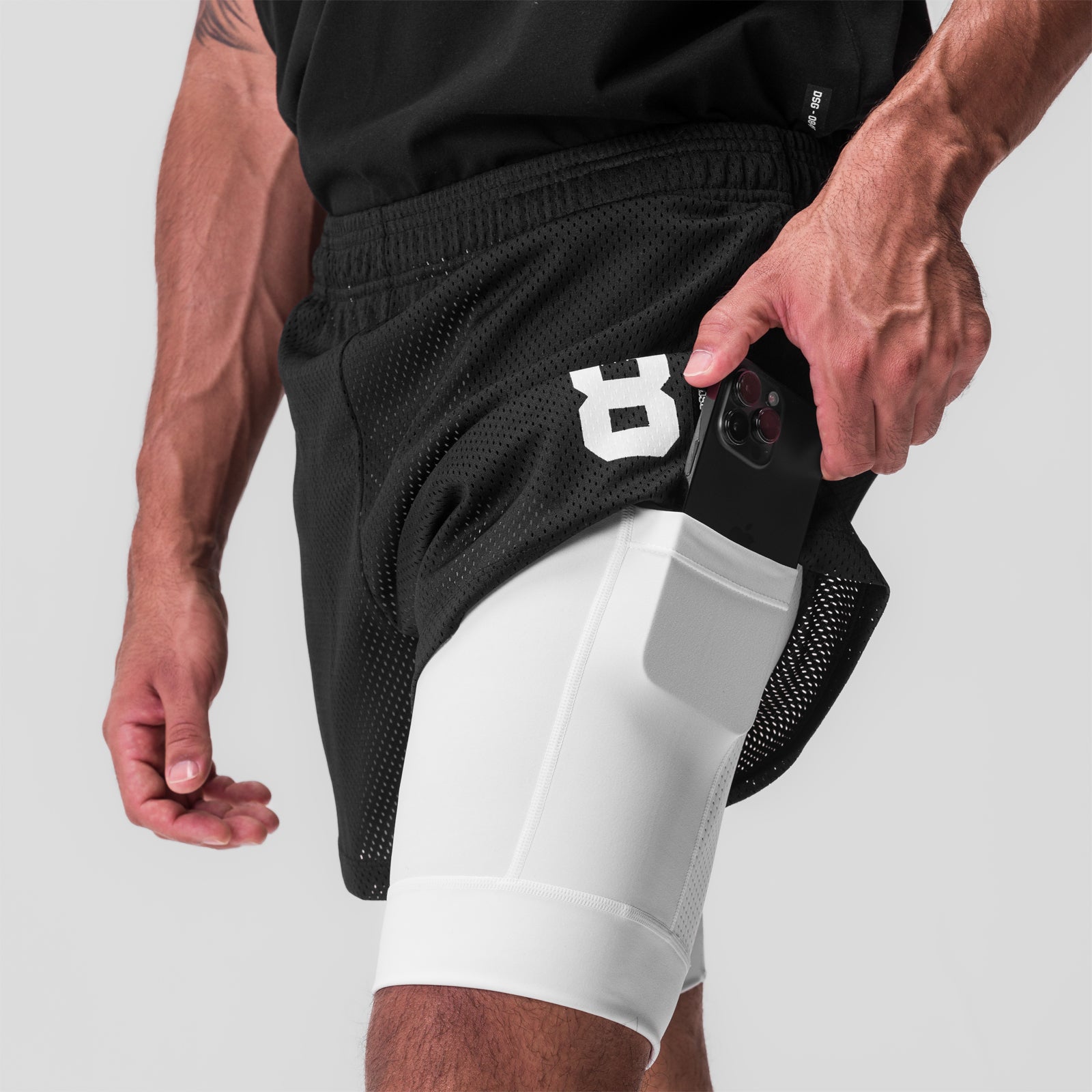 SilverPlus Mesh 5" Liner Short in Black/White, model wearing shorts with phone in pocket