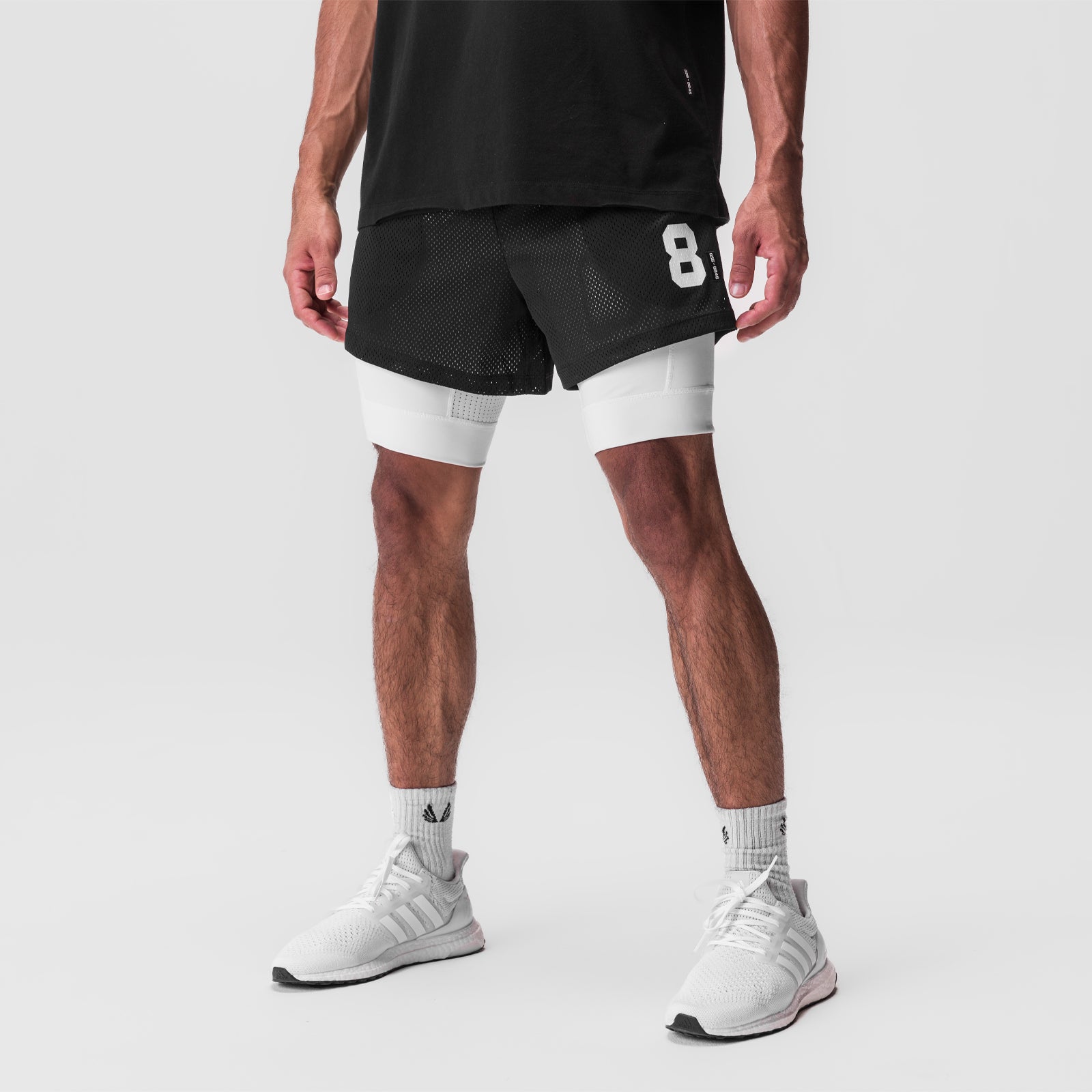 SilverPlus Mesh 5" Liner Short in black and white, worn on model with white socks and sneakers