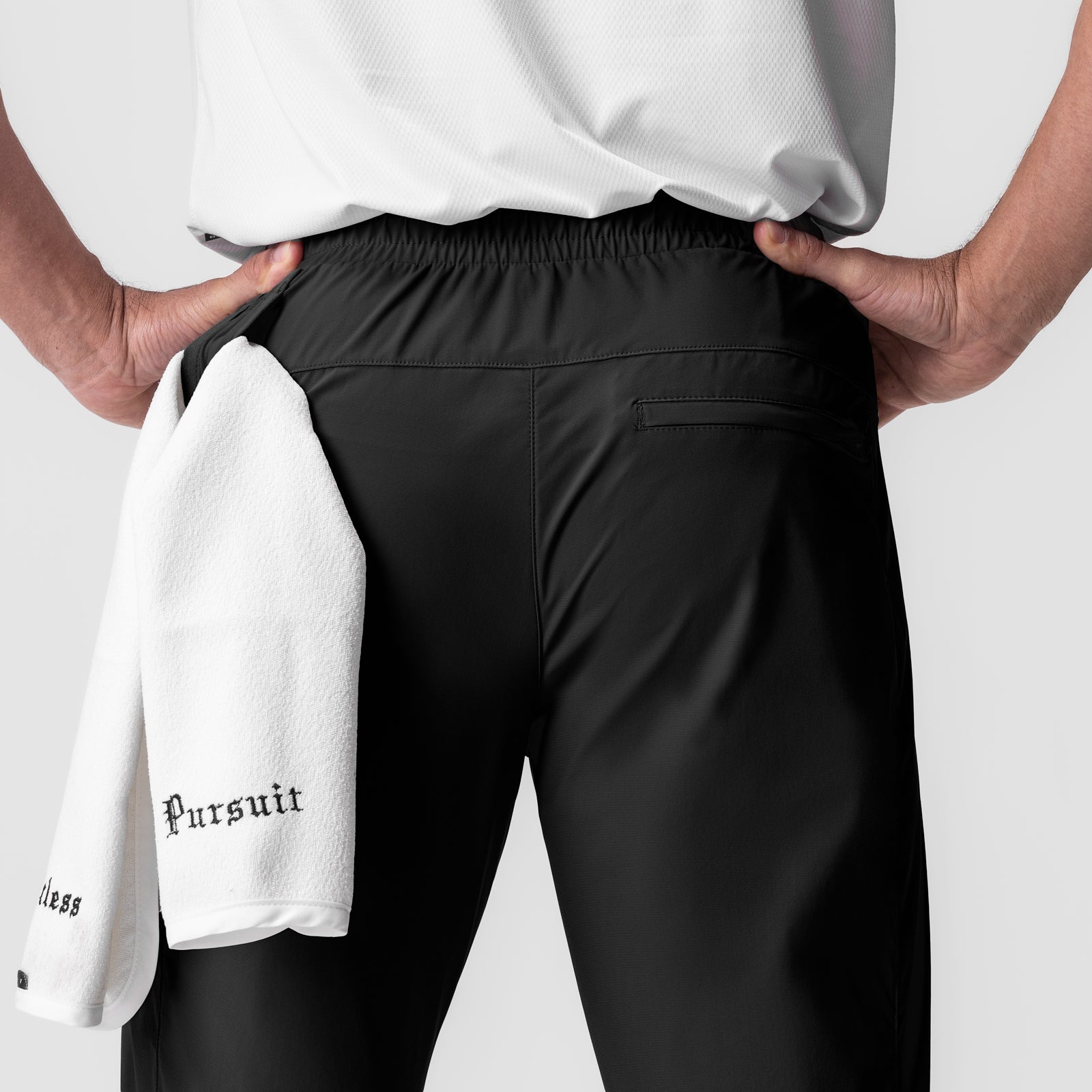 Black Tetra-Lite Moto Jogger worn by model, back view with white towel