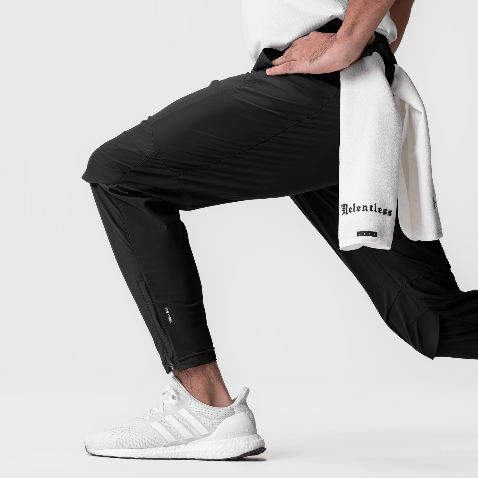 Tetra-Lite® Moto Jogger in black worn by model with white sneakers and towel