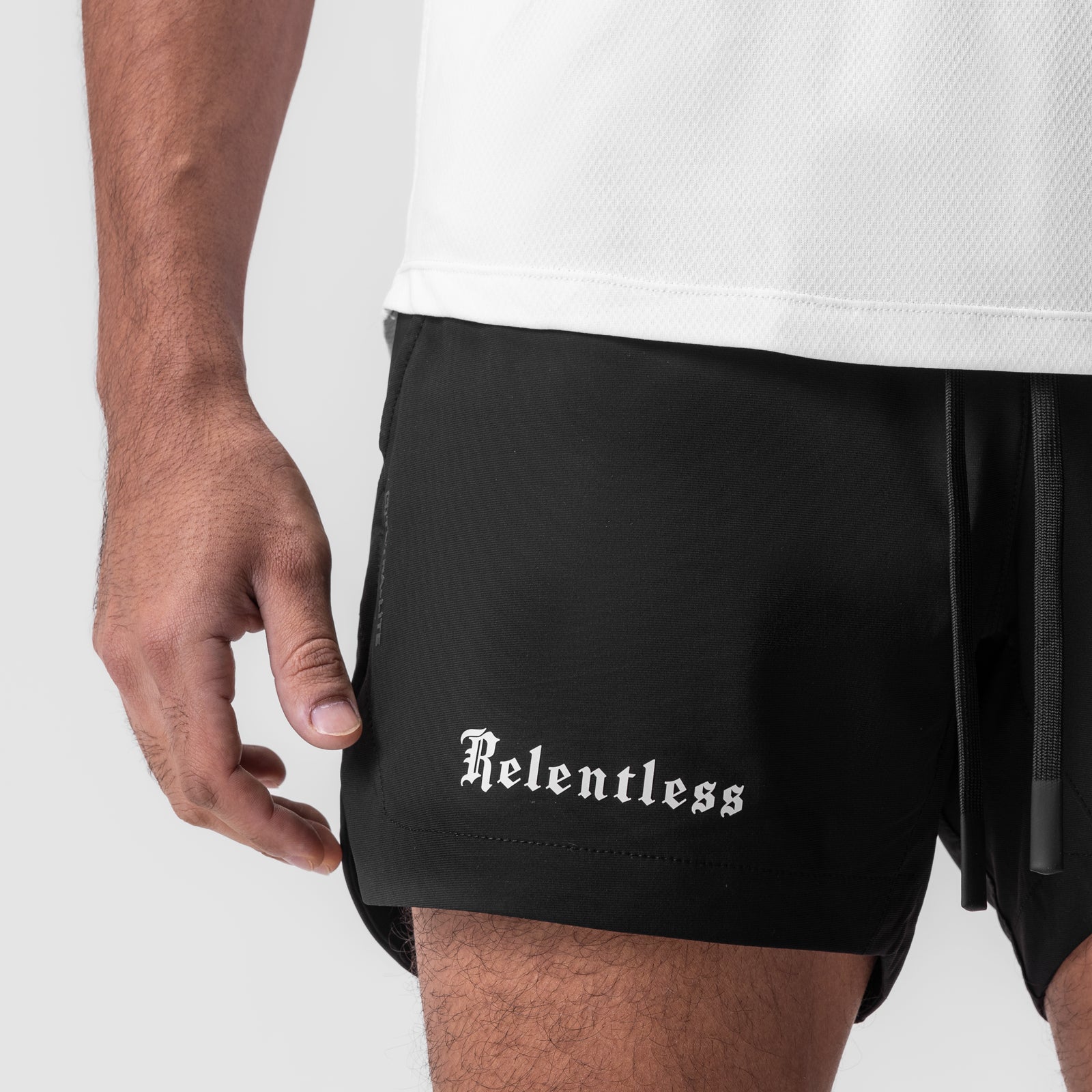 Tetra-Lite 5" linerless short in black, worn by model showing side detail with 'Relentless' branding