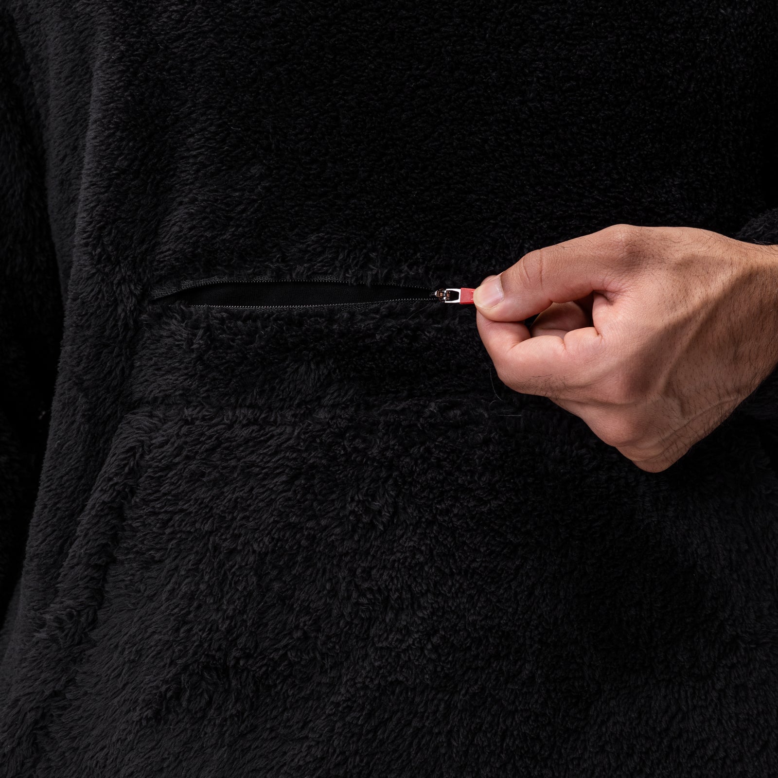 Black Sherpa Recovery Hoodie held open by hand to show zipper detail