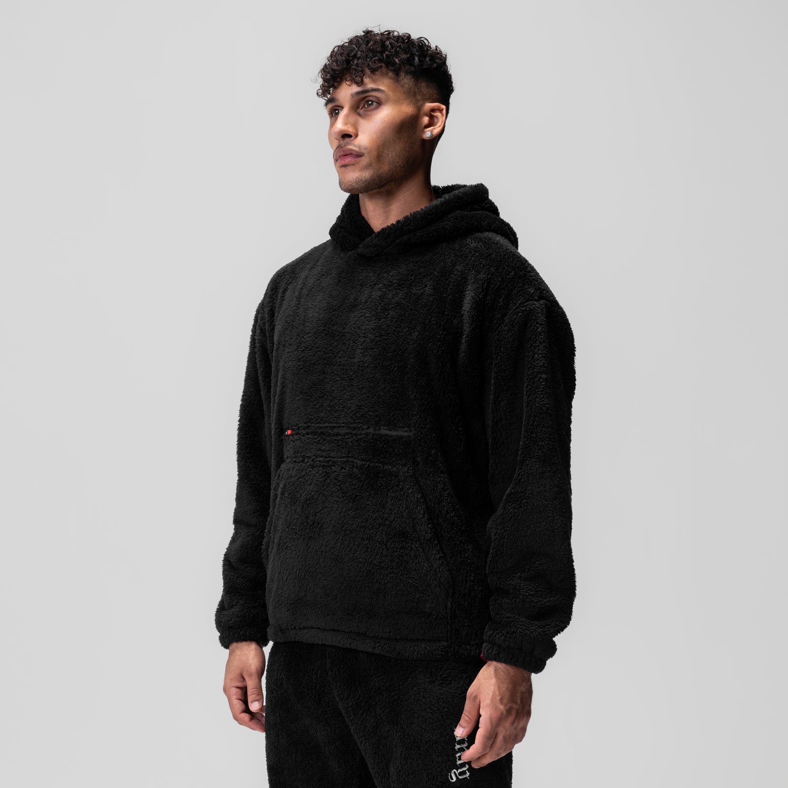 Black Sherpa Recovery Hoodie worn by model, three-quarter view