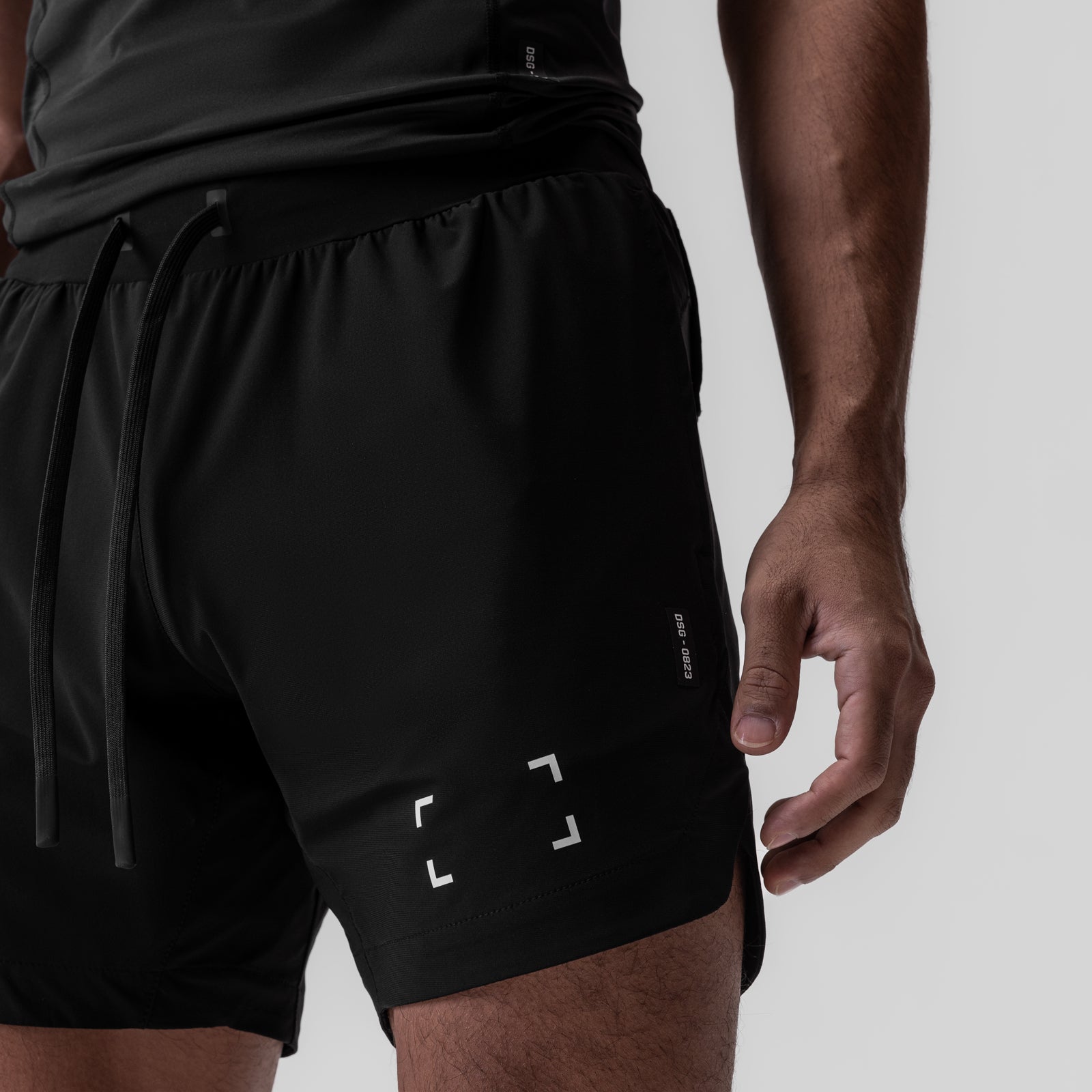 Black Tetra-Lite 7" Linerless Shorts with Space Bracket design, modeled on person, side view