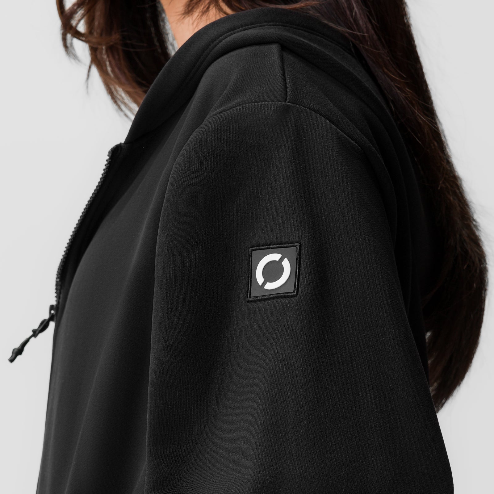 Black ASRV Sorona French-Terry Oversized Zip Hoodie worn by model, side view showing logo patch
