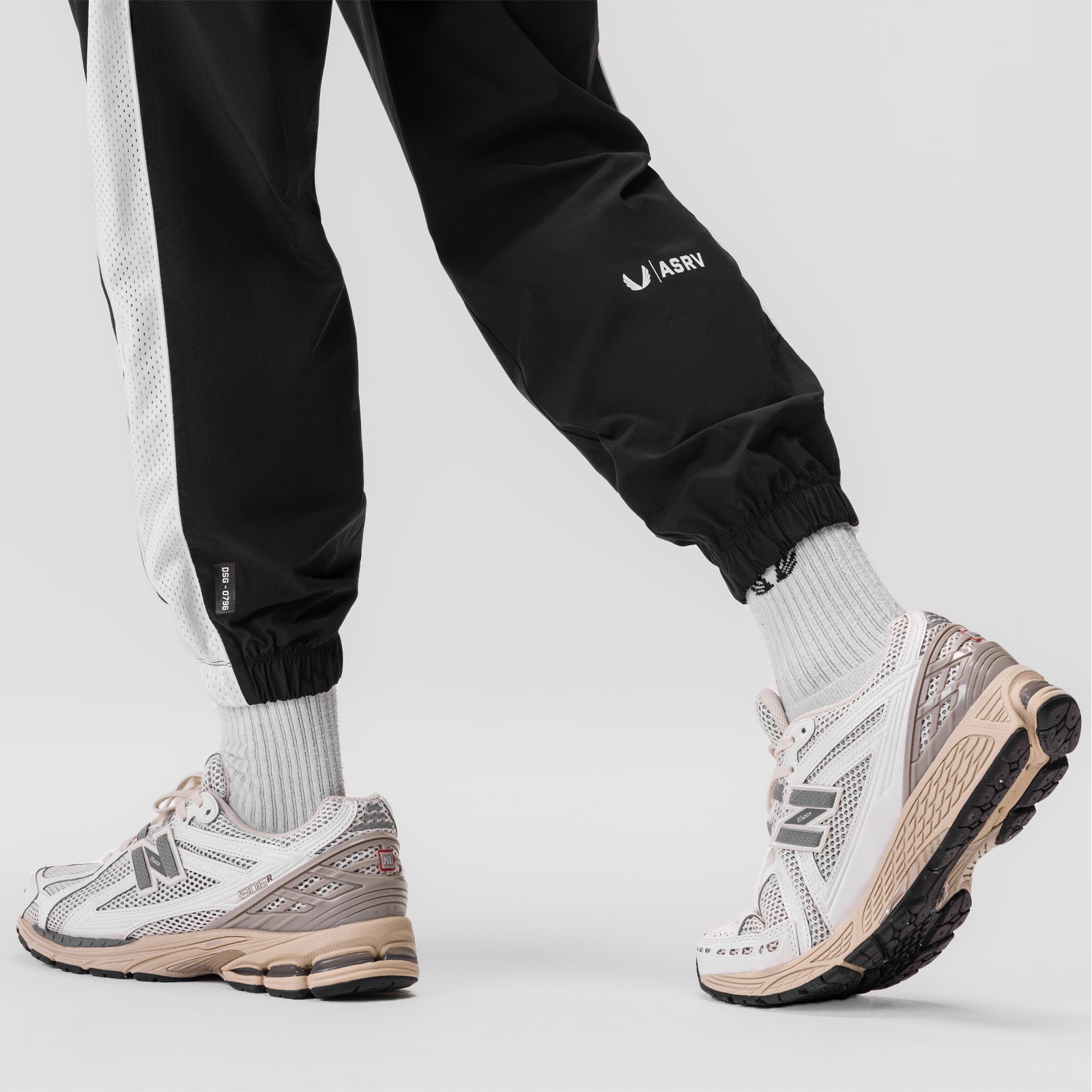 Ripstop Oversized Track Pant in black, worn with white socks and sneakers, lower body view