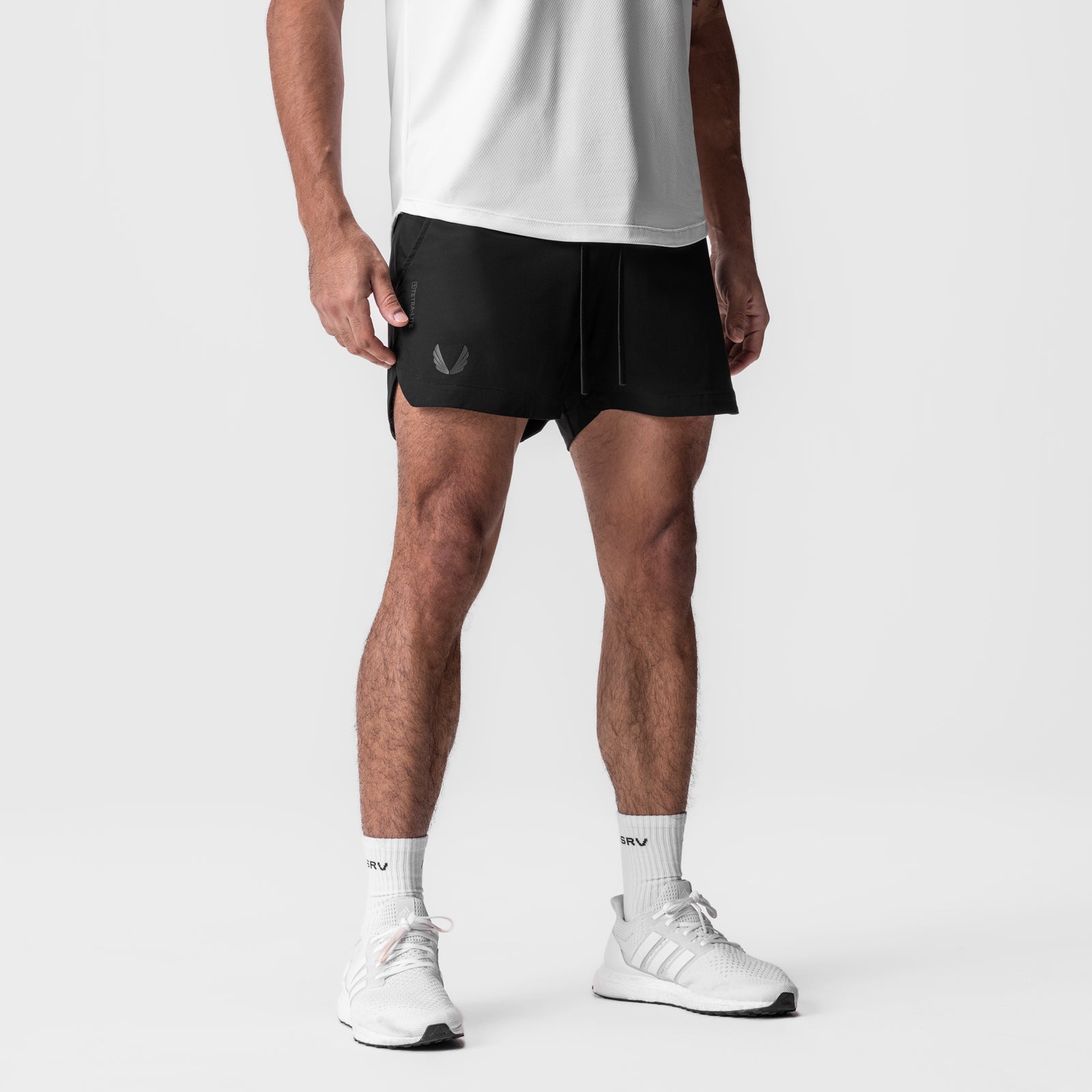 Tetra-Lite 5" Linerless Short in black, worn with white socks and sneakers, front view