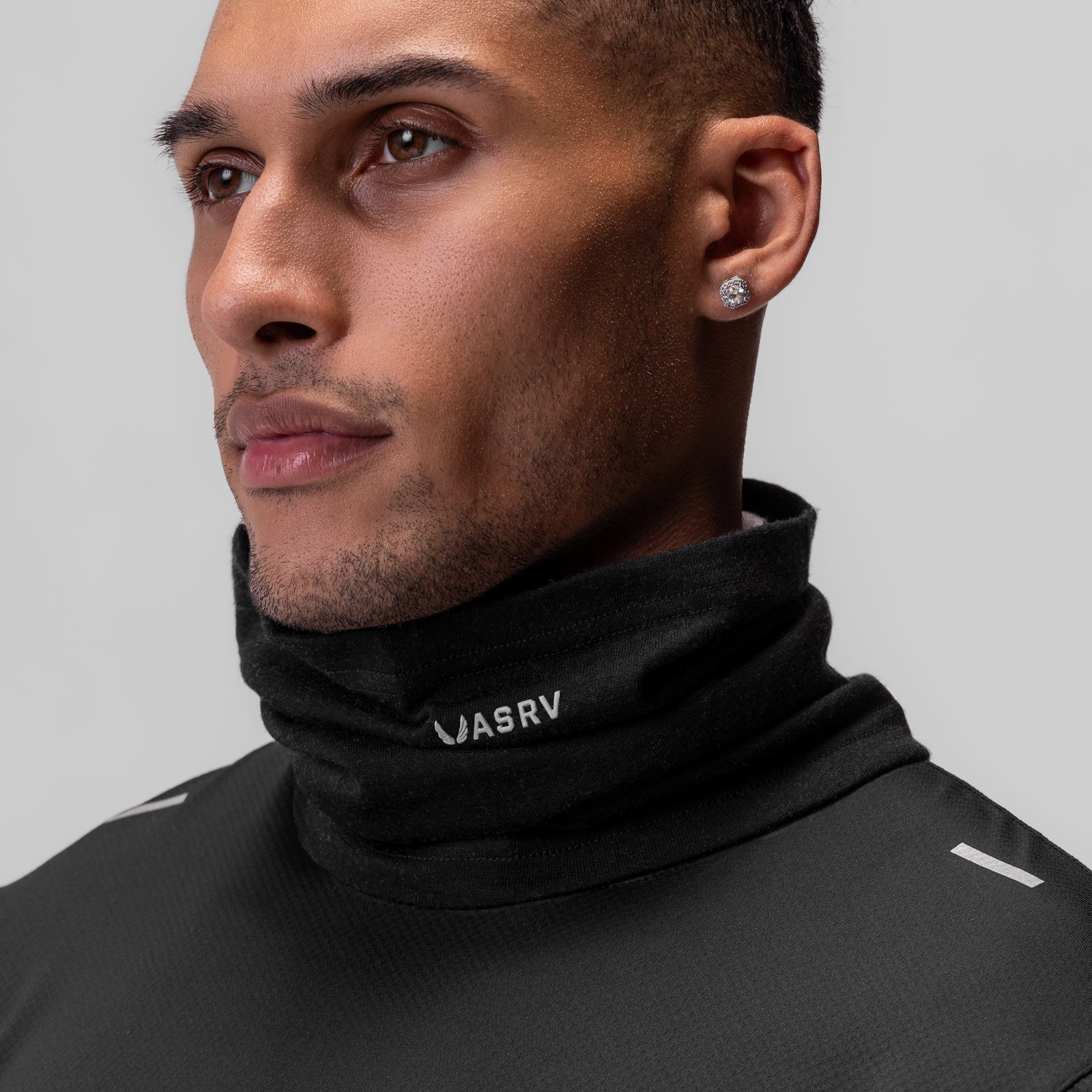 Black Merino Wool Gaiter worn as neck gaiter on model, side profile view