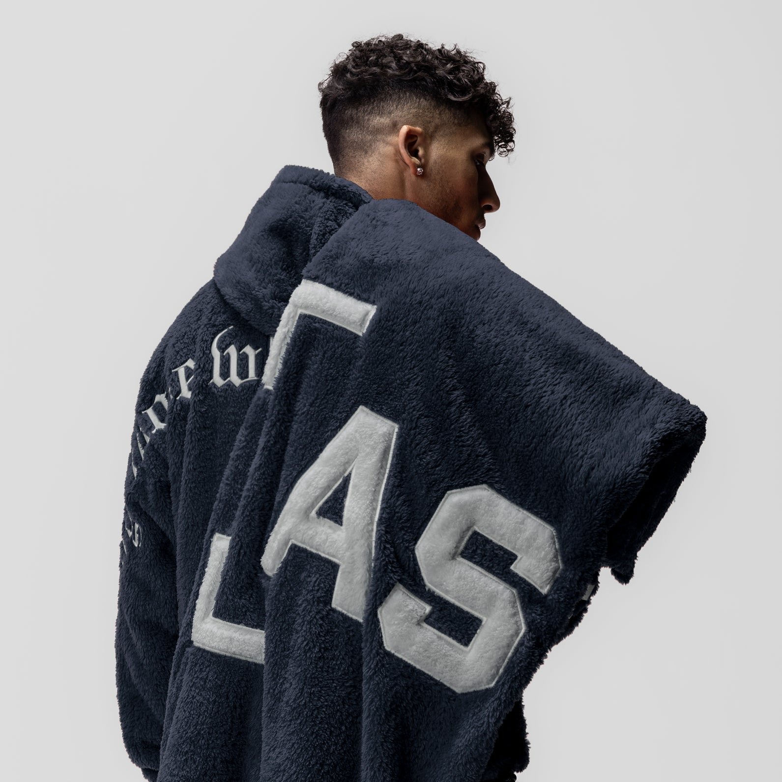 Navy sherpa recovery blanket with white '45' lettering, worn by model from behind