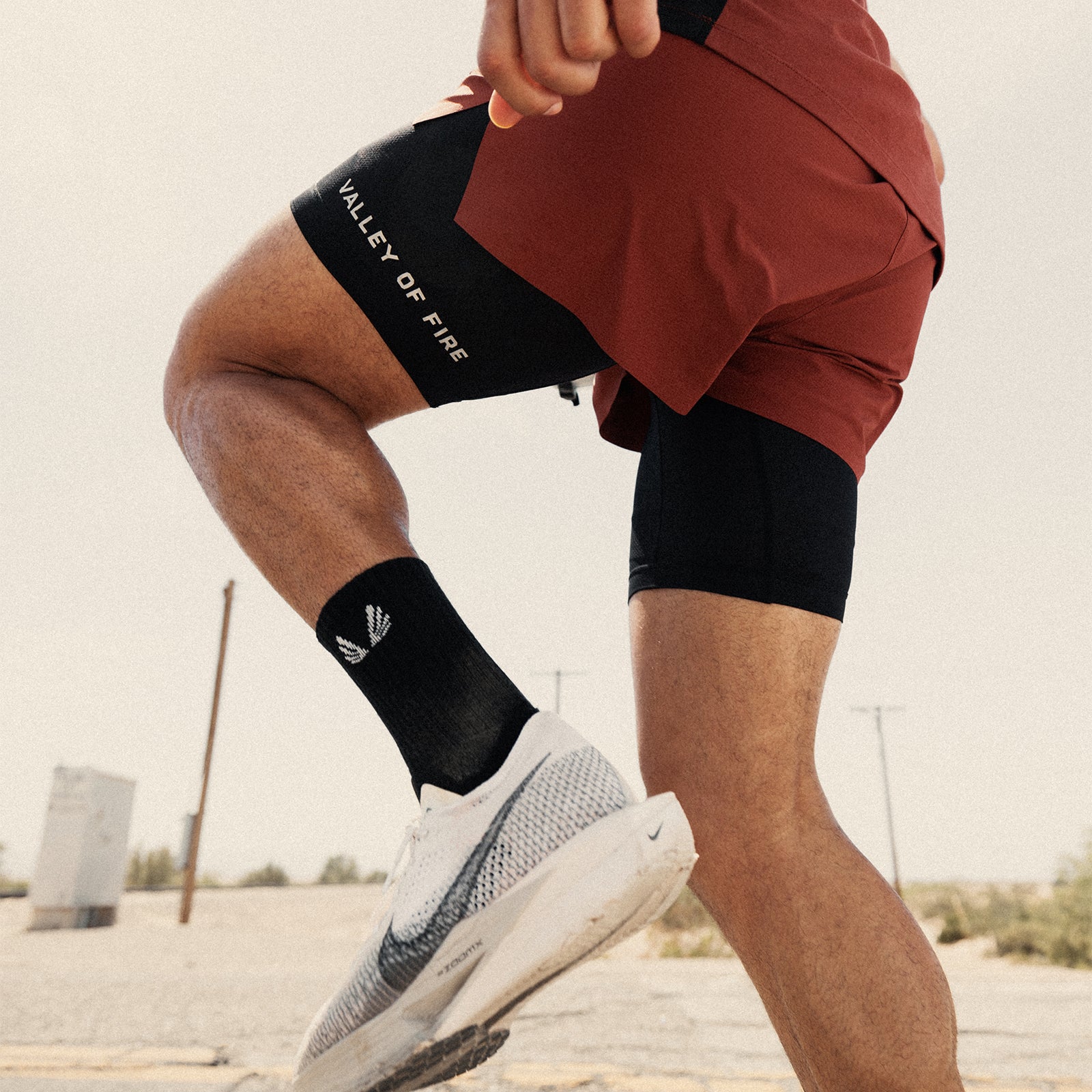 Ripstop 3" Belt Pack Short in brick red and black worn by model running outdoors