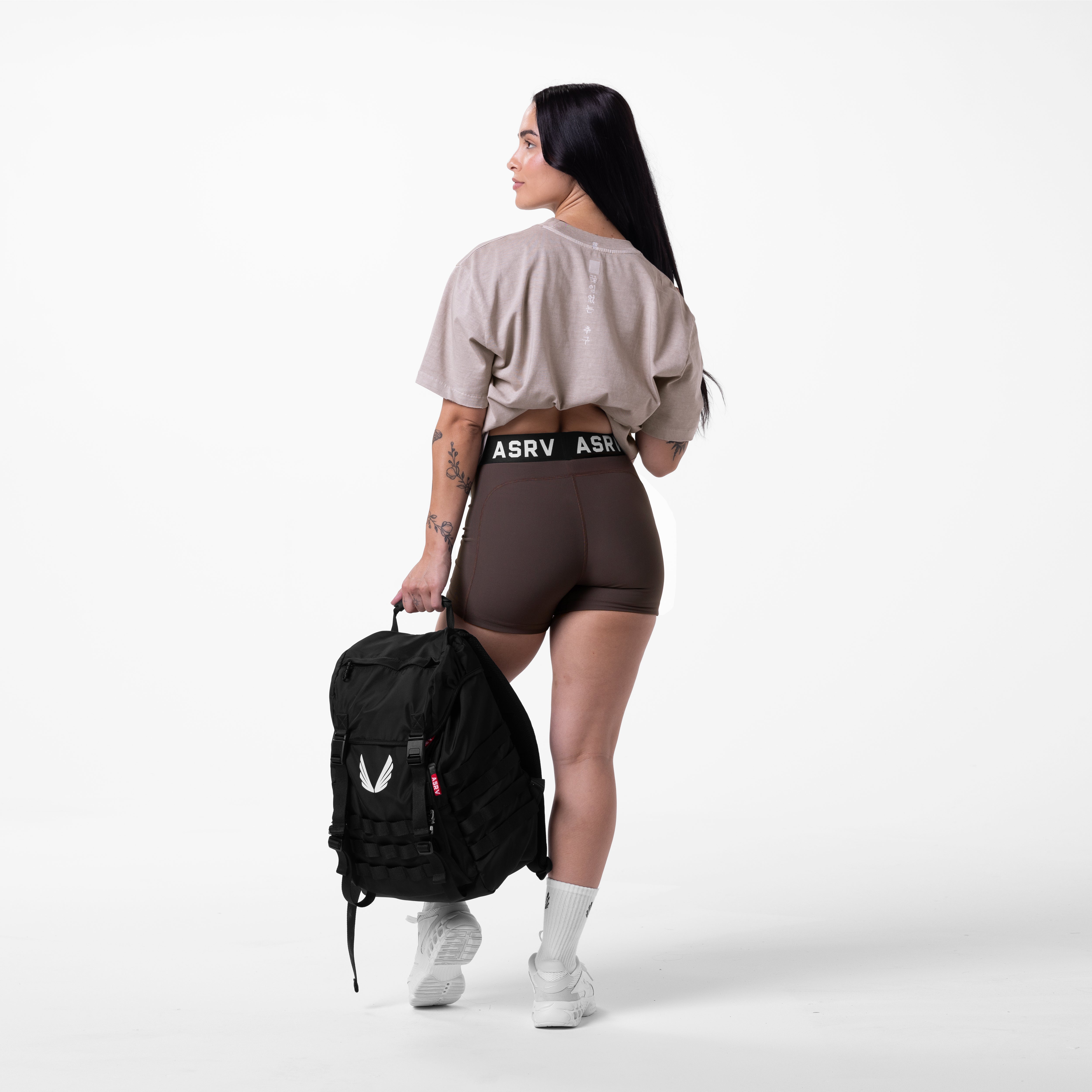 Tech Essential Relaxed Tee in Faded Chai worn with brown shorts, back view