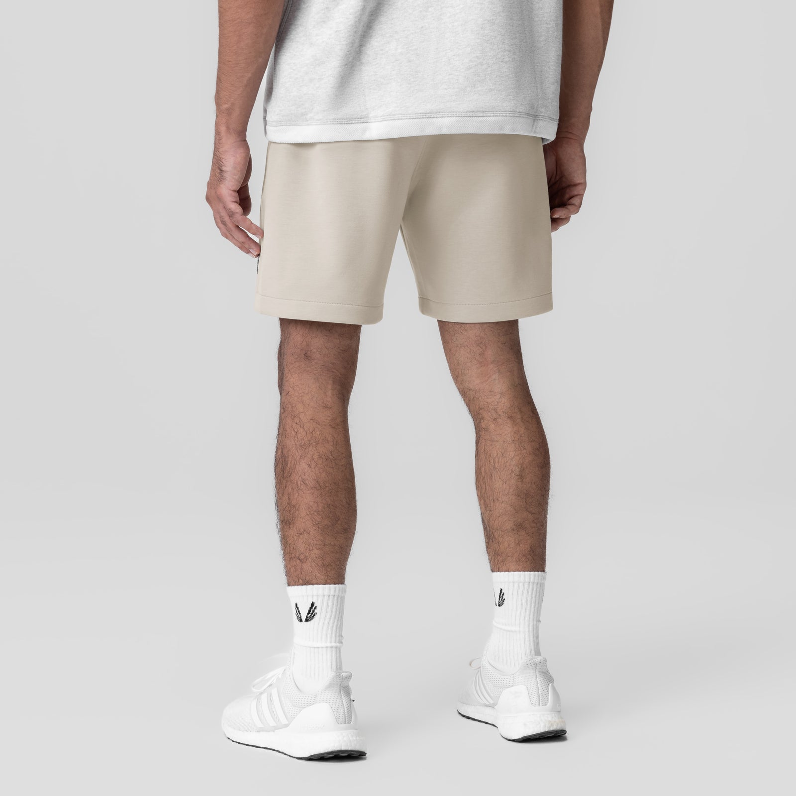 Dri-Core™ Training Short in Chai worn by model, back view with white socks and sneakers
