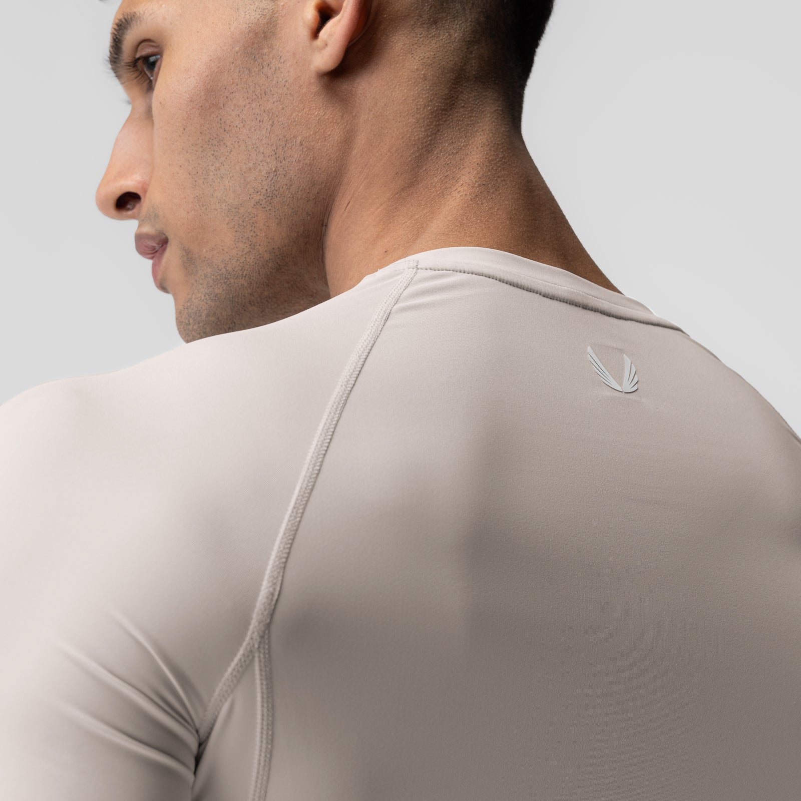 WarpFlexx-Lite® Half-Sleeve Baselayer in Chai, worn by model shown from back angle