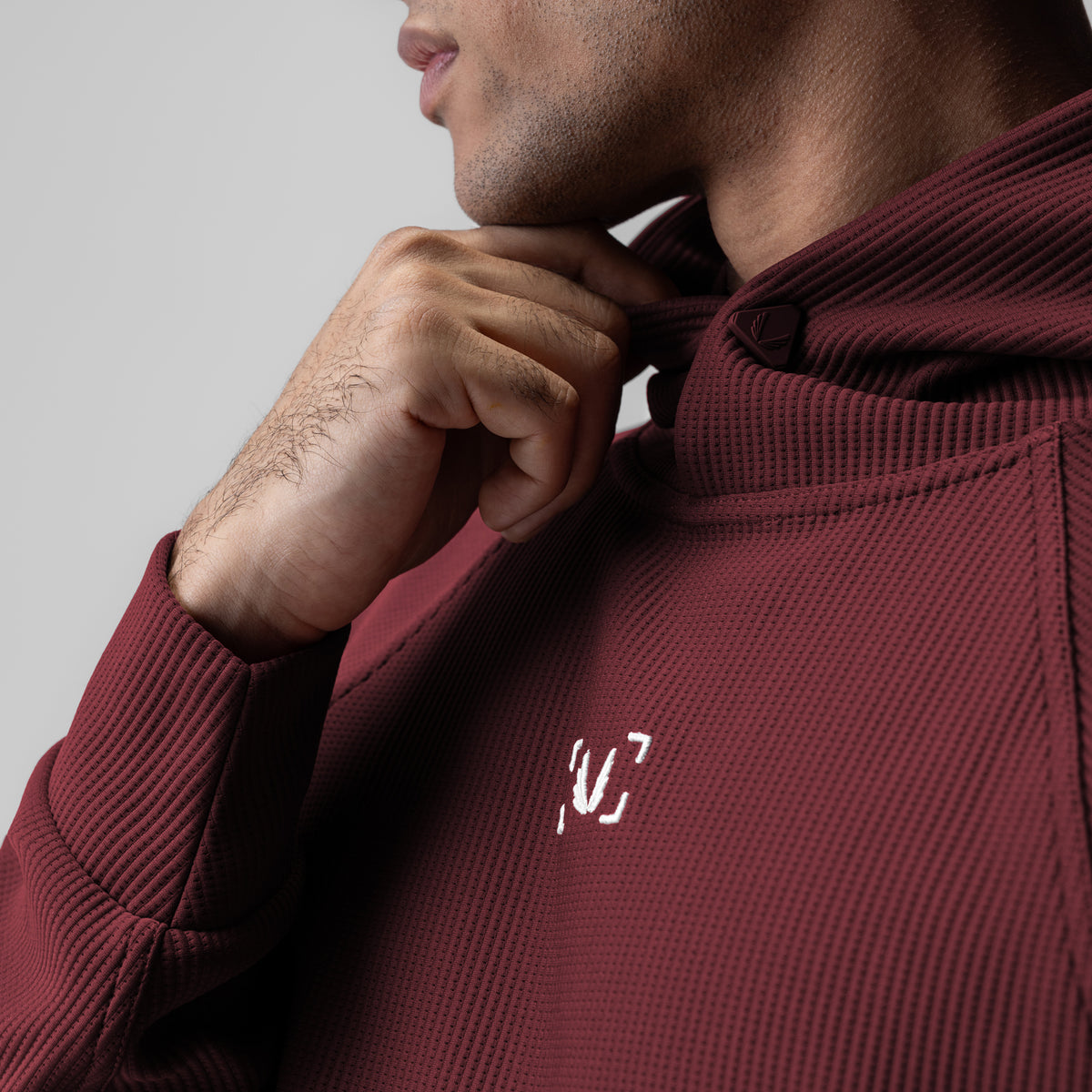 Deltapeak® Oversized Hoodie in crimson, worn by model adjusting drawstring