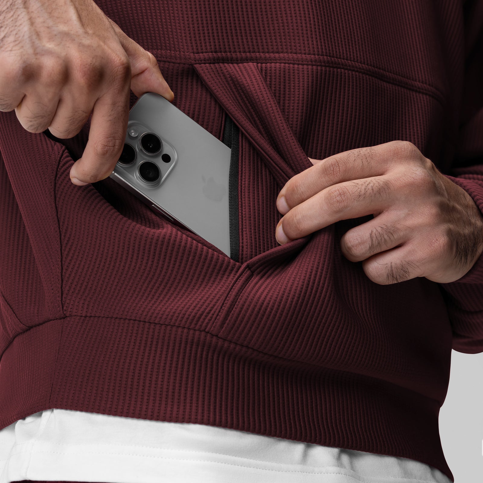 Deltapeak® Oversized Hoodie in Crimson, worn by model holding smartphone in pocket